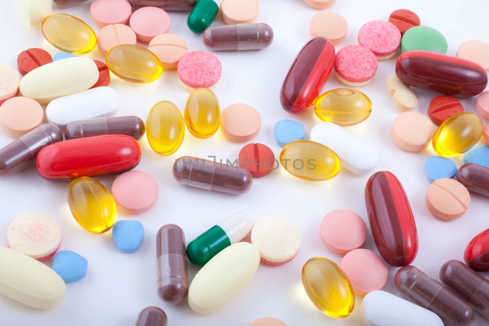 An assortment of pills, tablets and capsules on white background