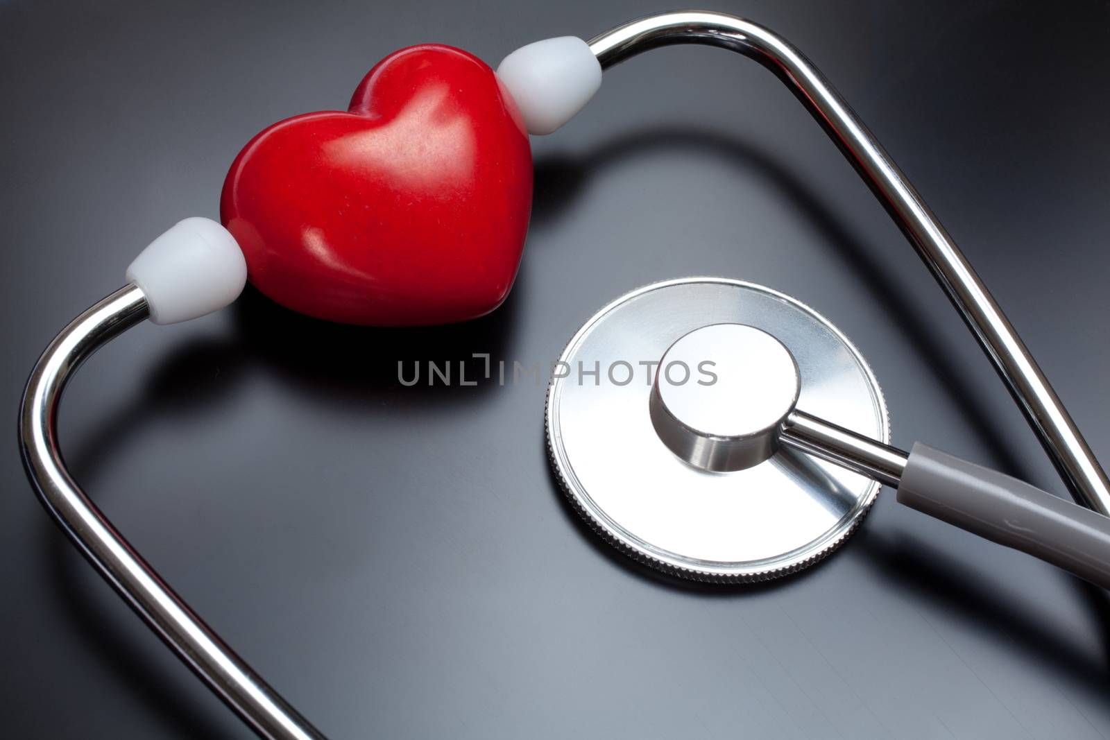 Stethoscope & red heart on X-ray background