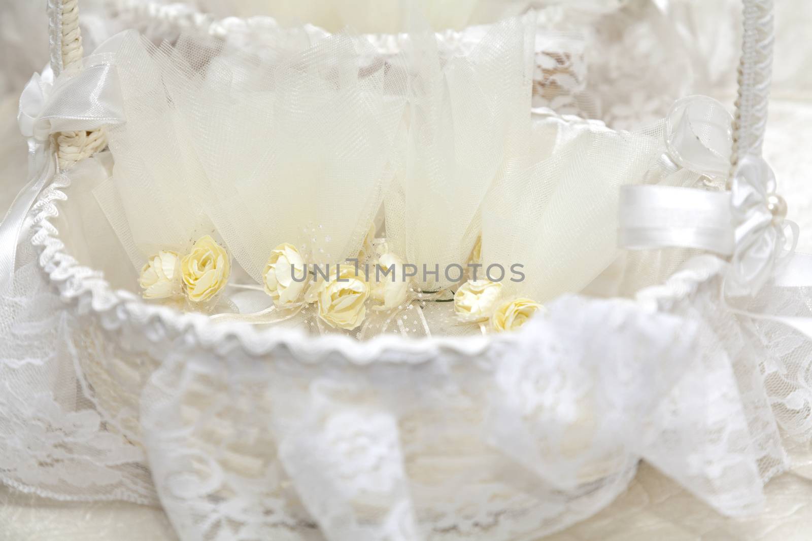 Elegant Wedding Favors decorated with artificial flowers in basket