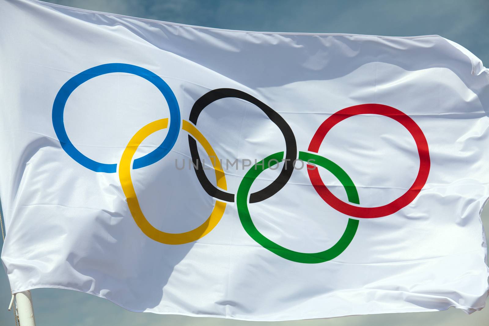 THESSALONIKI, GREECE - MAY 13: At the event of arrival of the Olympic flame in Thessaloniki the flag of the Olympic Games flew into the blue sky on May 13, 2012 in Thessaloniki, Greece