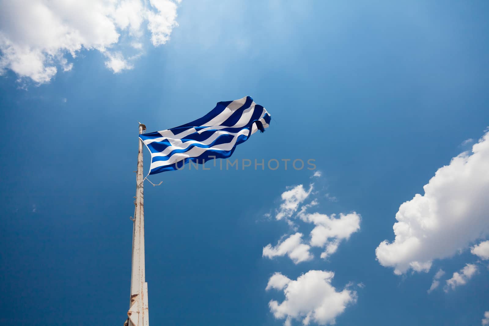 National flag of Greece waving over blue sky