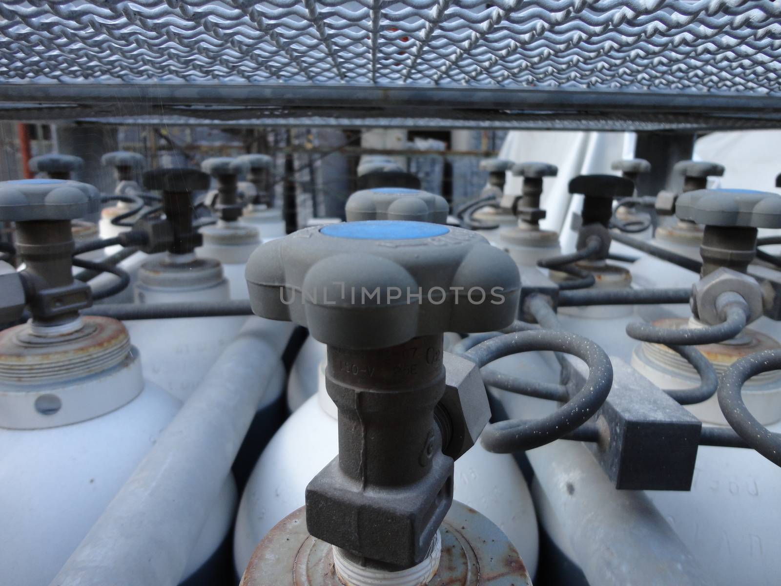 Bottled Valves of an industrial stock of used bottled/cylinders. Manufacture factory of granites