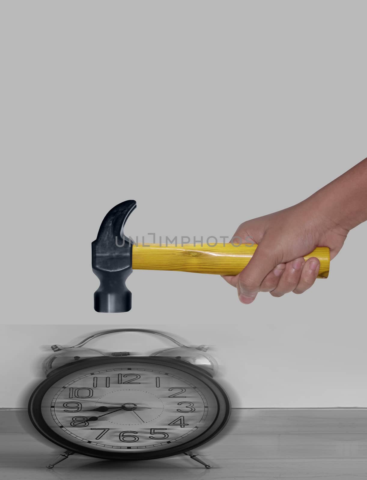 Hammer in Human Hand hitting Alarm Clock with motion blur