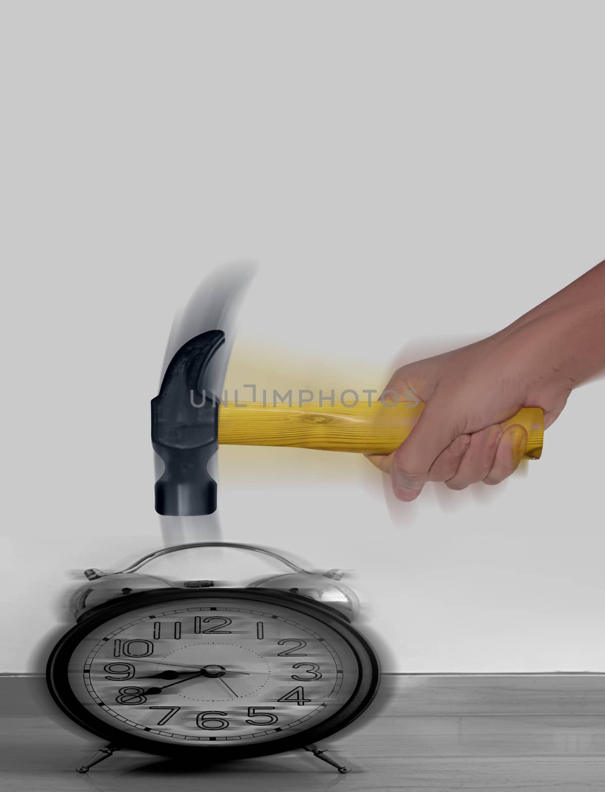 Hammer in Human Hand hitting Alarm Clock with motion blur