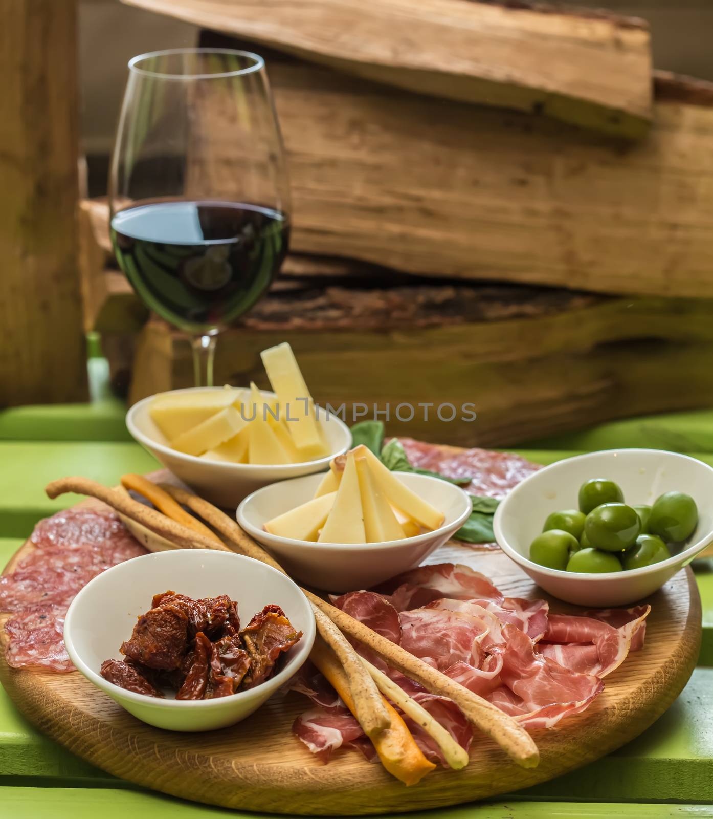 different italian antipasti and red wine. selective focus