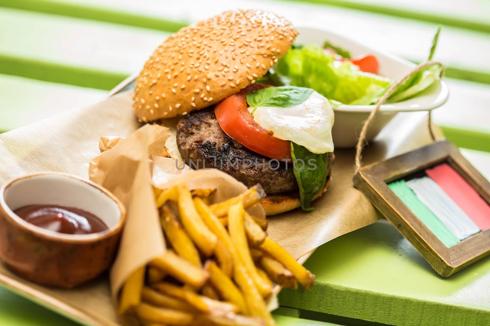 Delicious burger with beef, tomato, lettuce and fries. selective focus