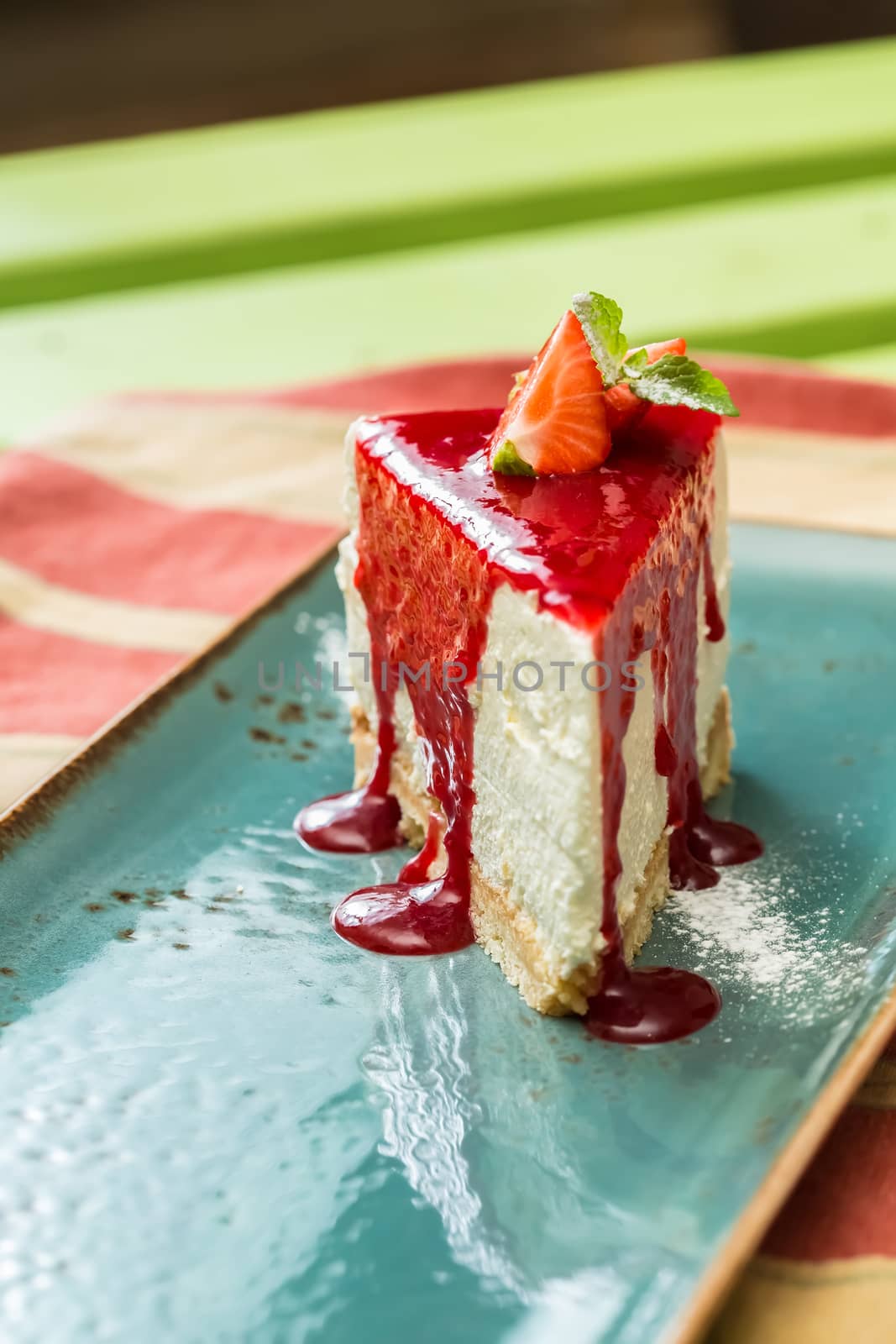 Dessert - Cheesecake with Berries Sauce and Green Mint. selective Focus