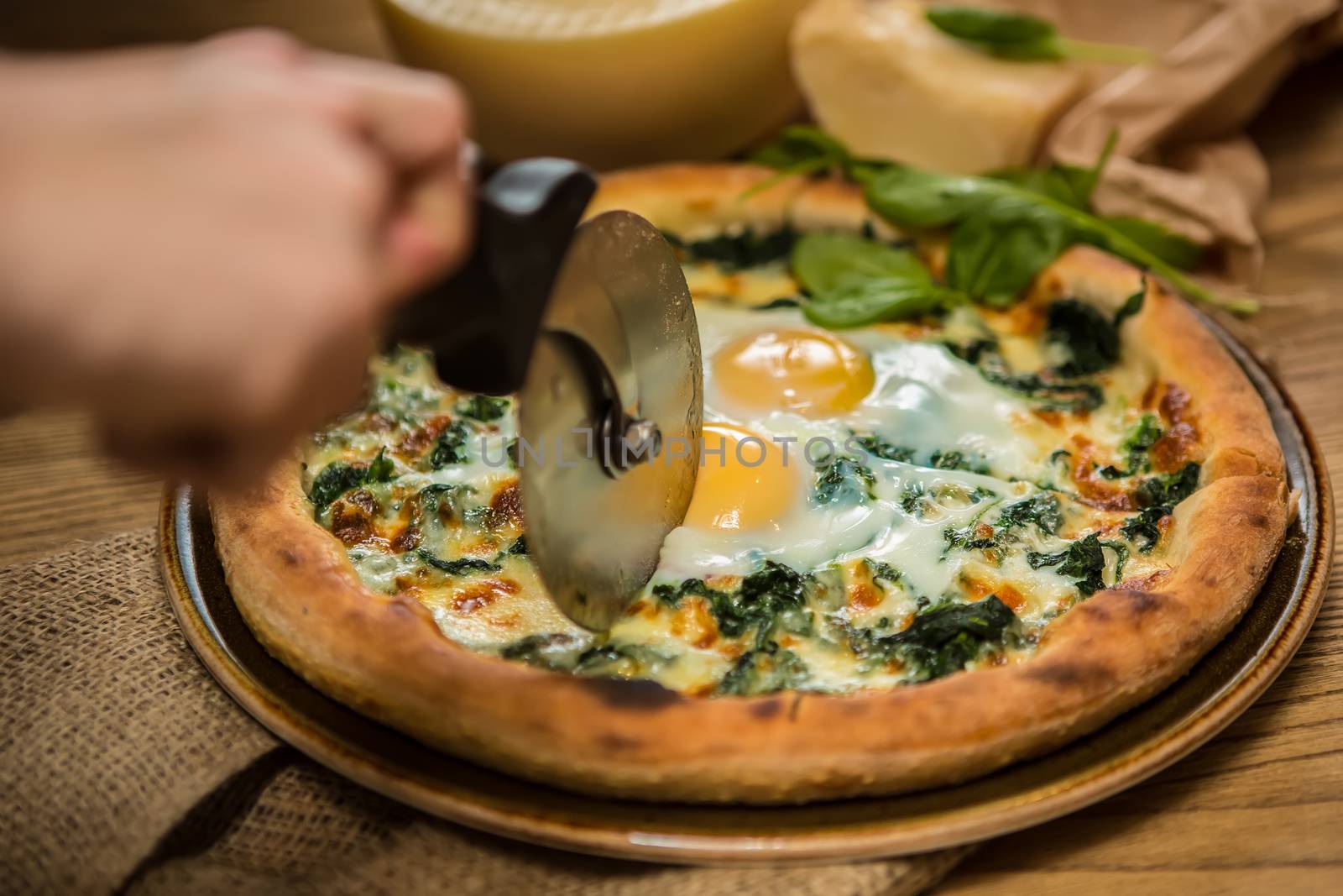 Margarita pizza with arugula and egg for breakfast, selective focus