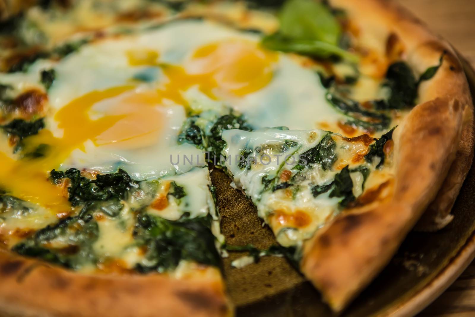 Margarita pizza with arugula and egg for breakfast, selective focus