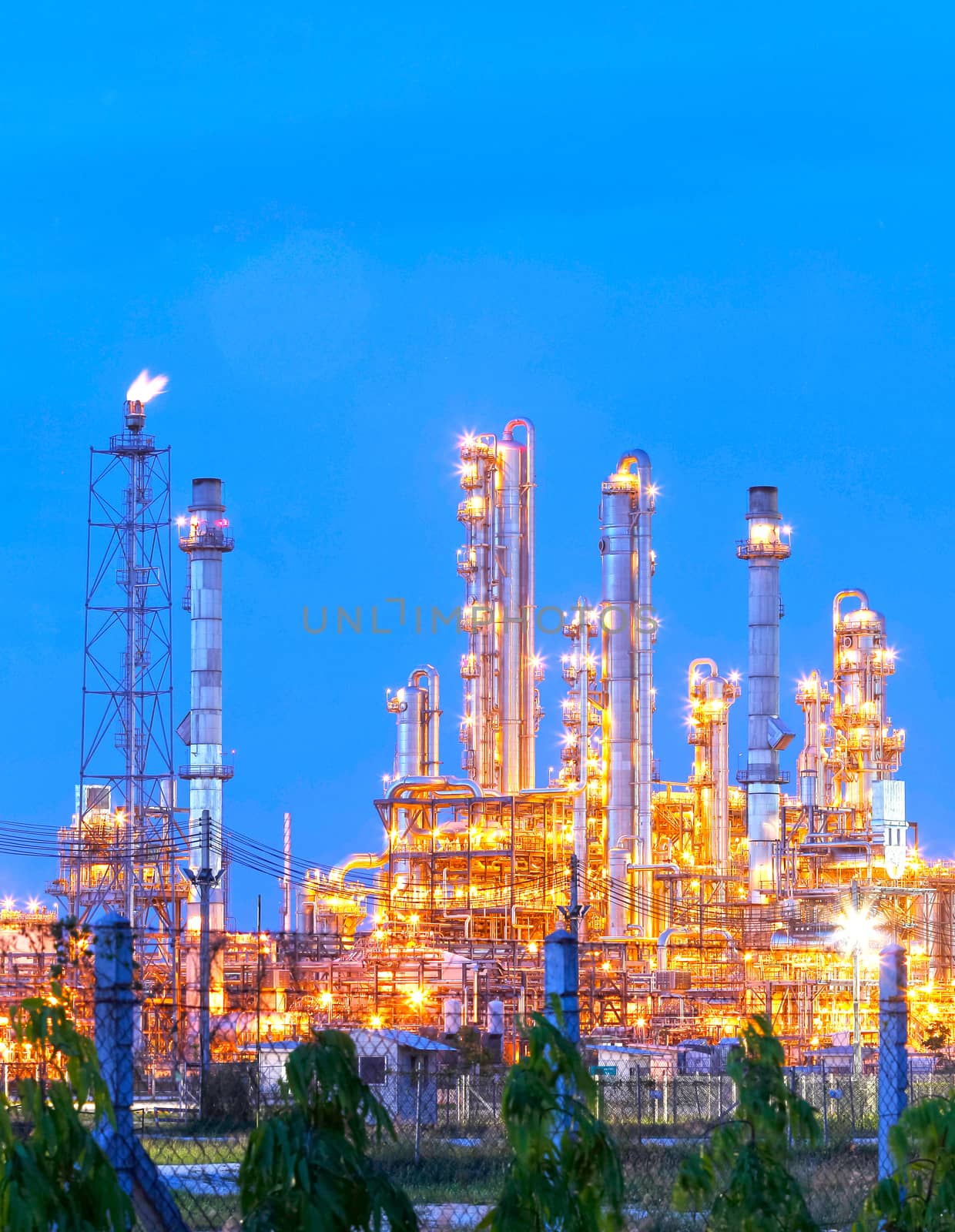 Lighting from structure of oil and chemical factory with blue sky background