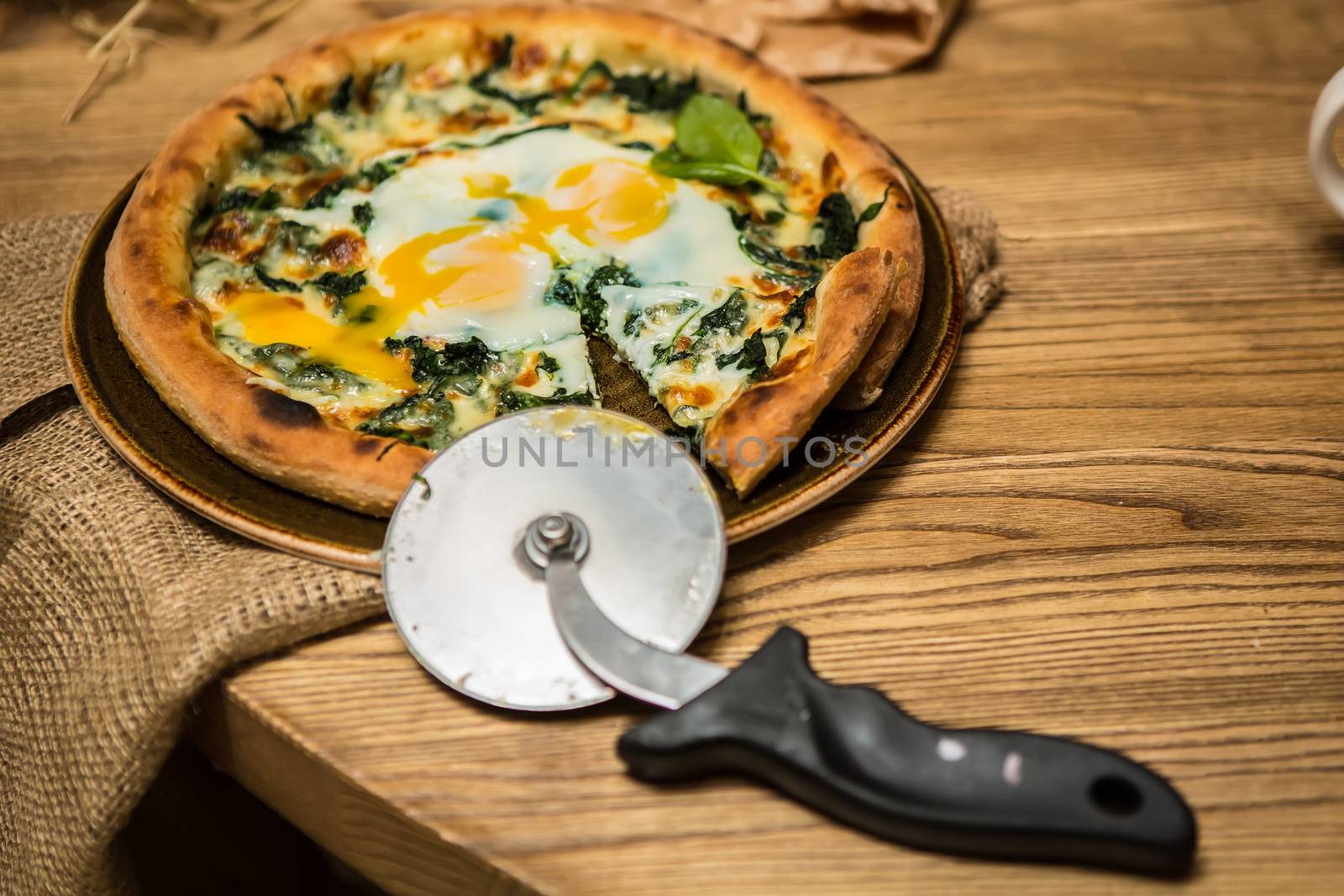 Margarita pizza with arugula and egg for breakfast, selective focus