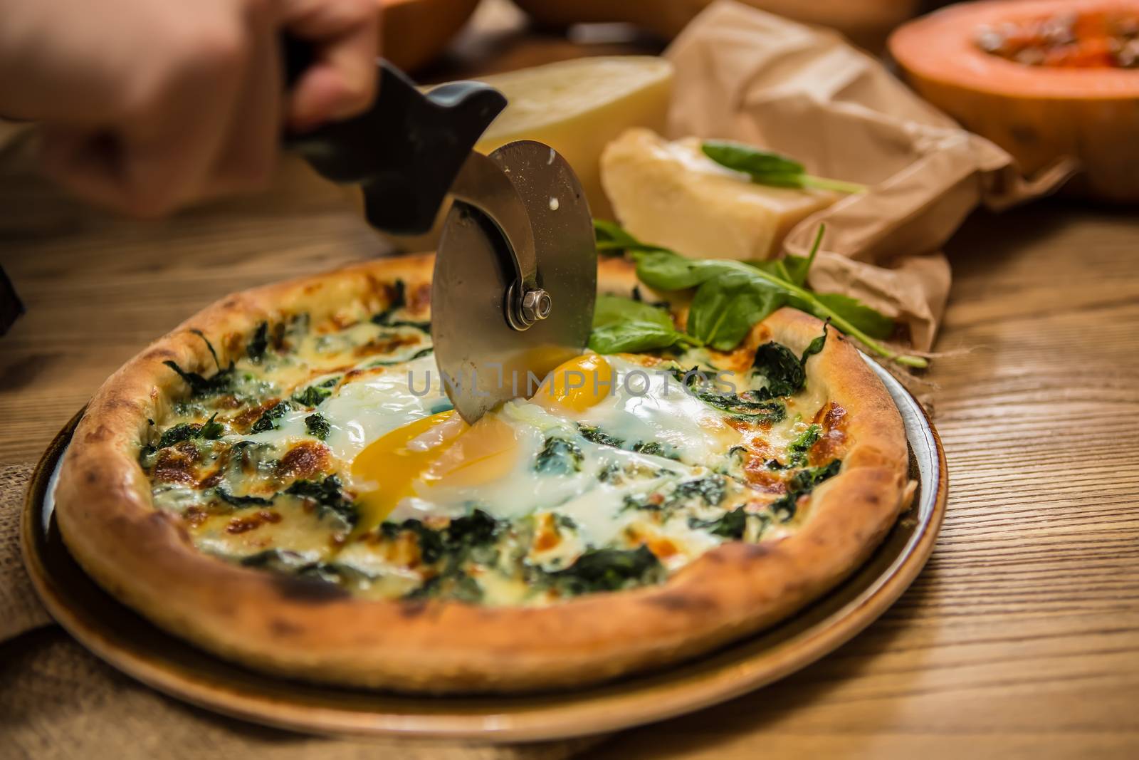 Margarita pizza with arugula and egg for breakfast, selective focus