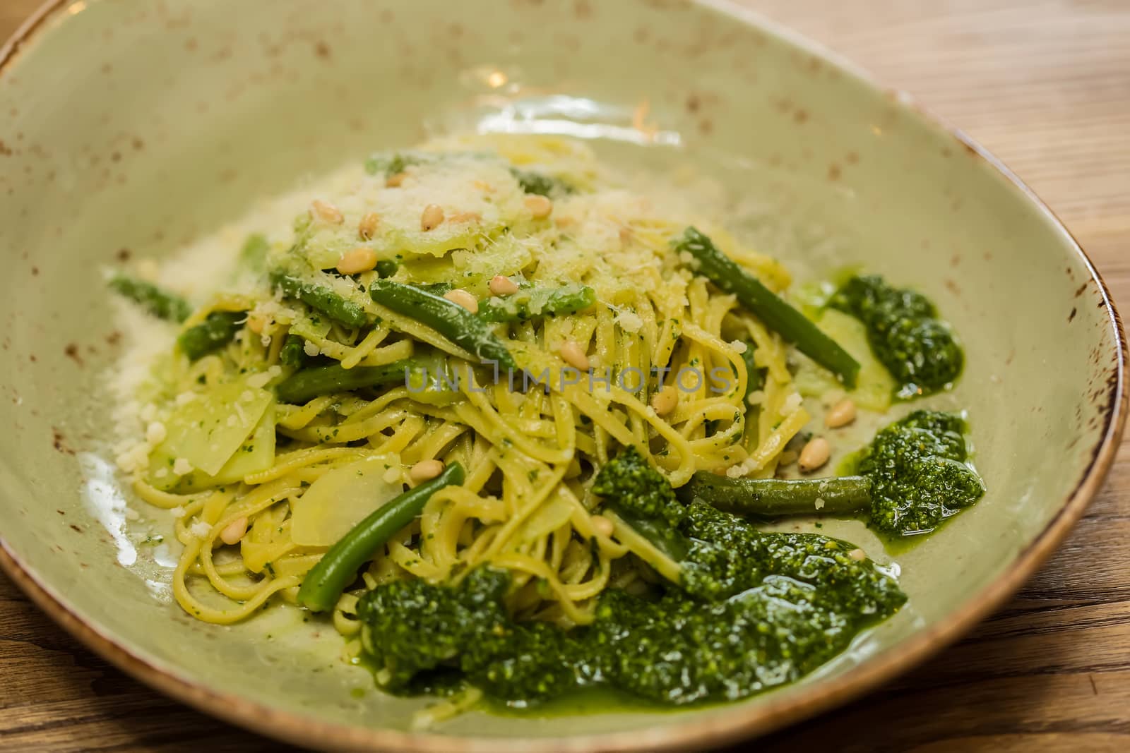 Italian pasta with pesto sauce close-up. Shallow dof.