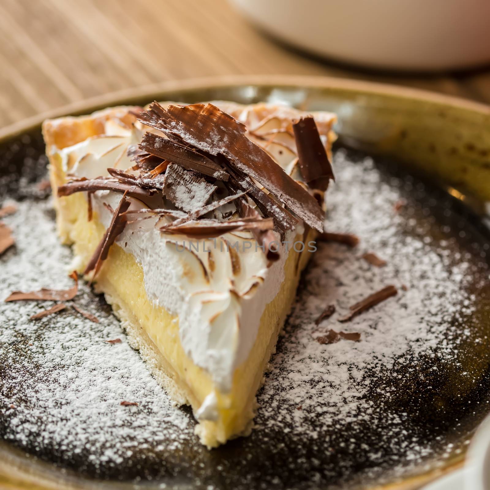 Cheesecake with Chocolate, baked to perfection. On plate with terracotta background. 