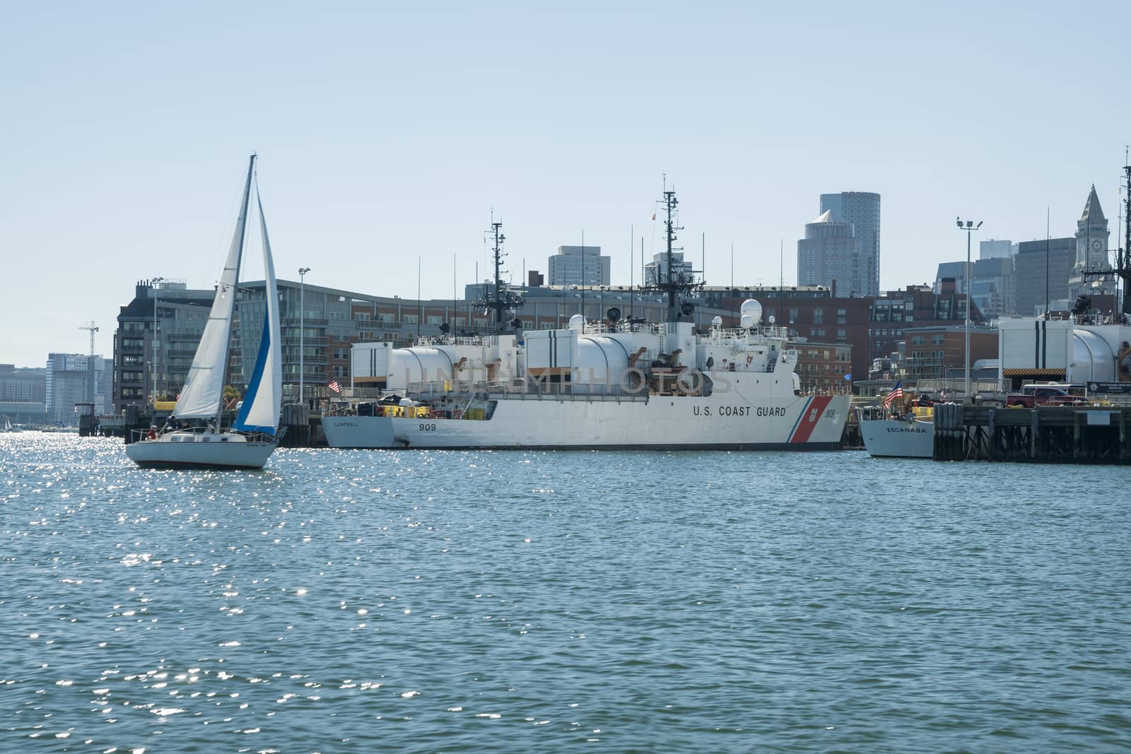 BOSTON, USA - OCTOBER 13; Boston harbor and USS Coastguard boat Campbell moored as yacht sails by on October 13, 2014 in Boston, USA.