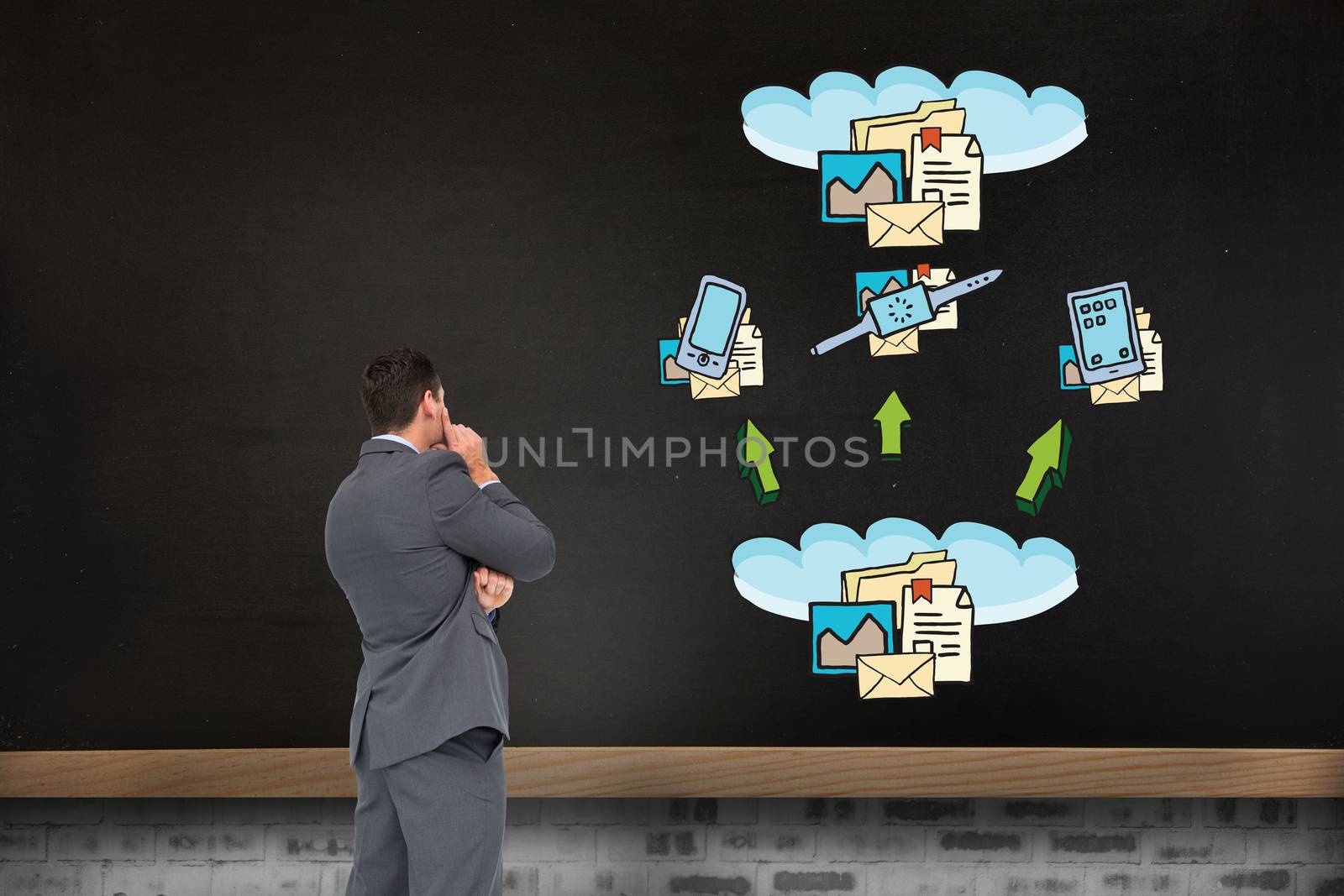 Thinking businessman against blackboard on wall with business technology doodle