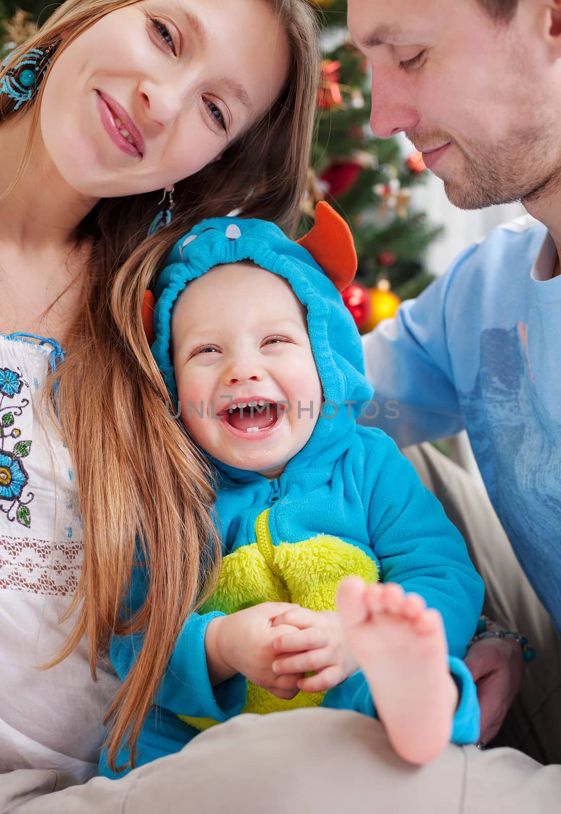 Young parents with baby son dressed in costume by photobac