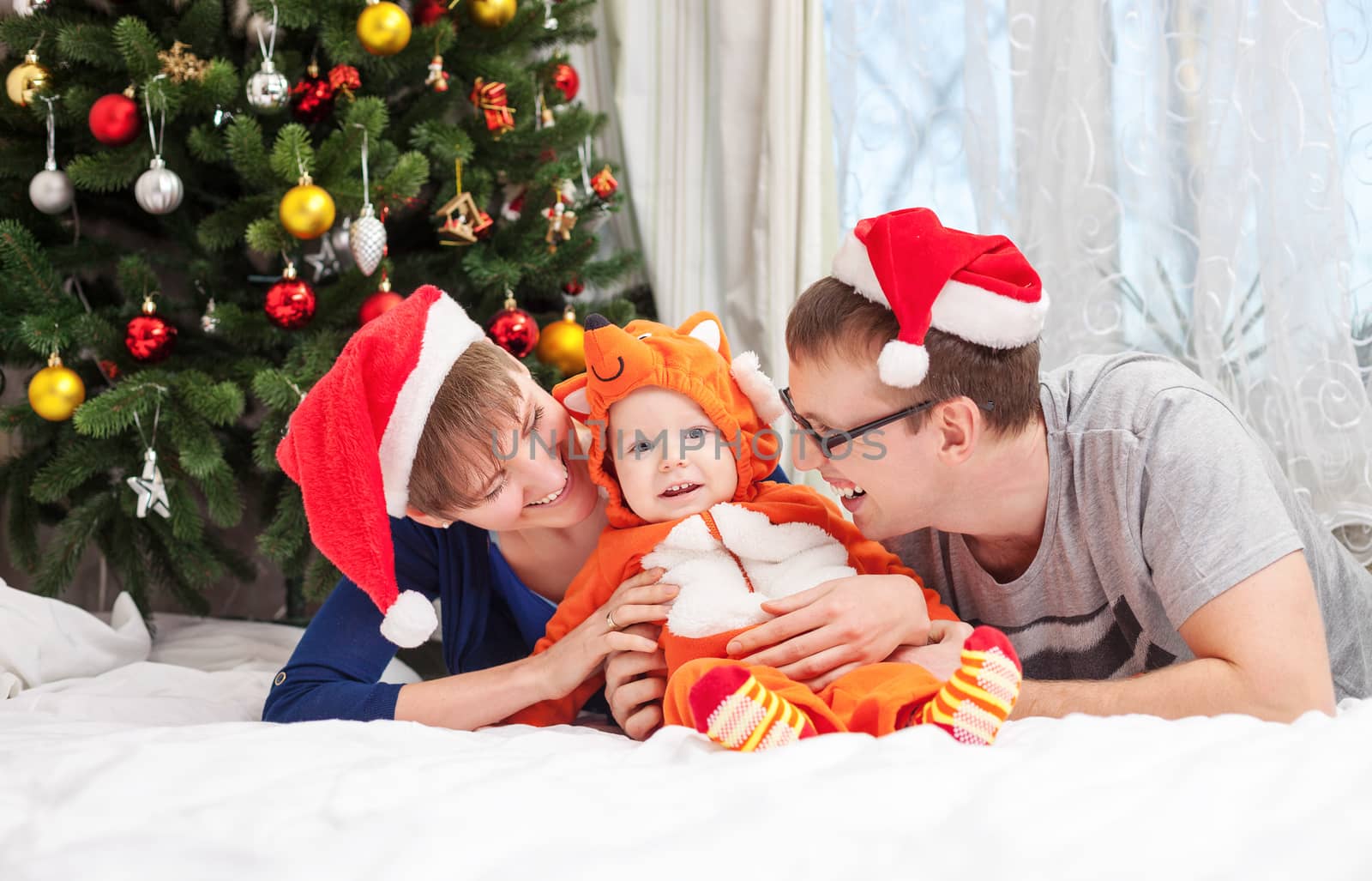 Young family with baby boy dressed in little fox costume