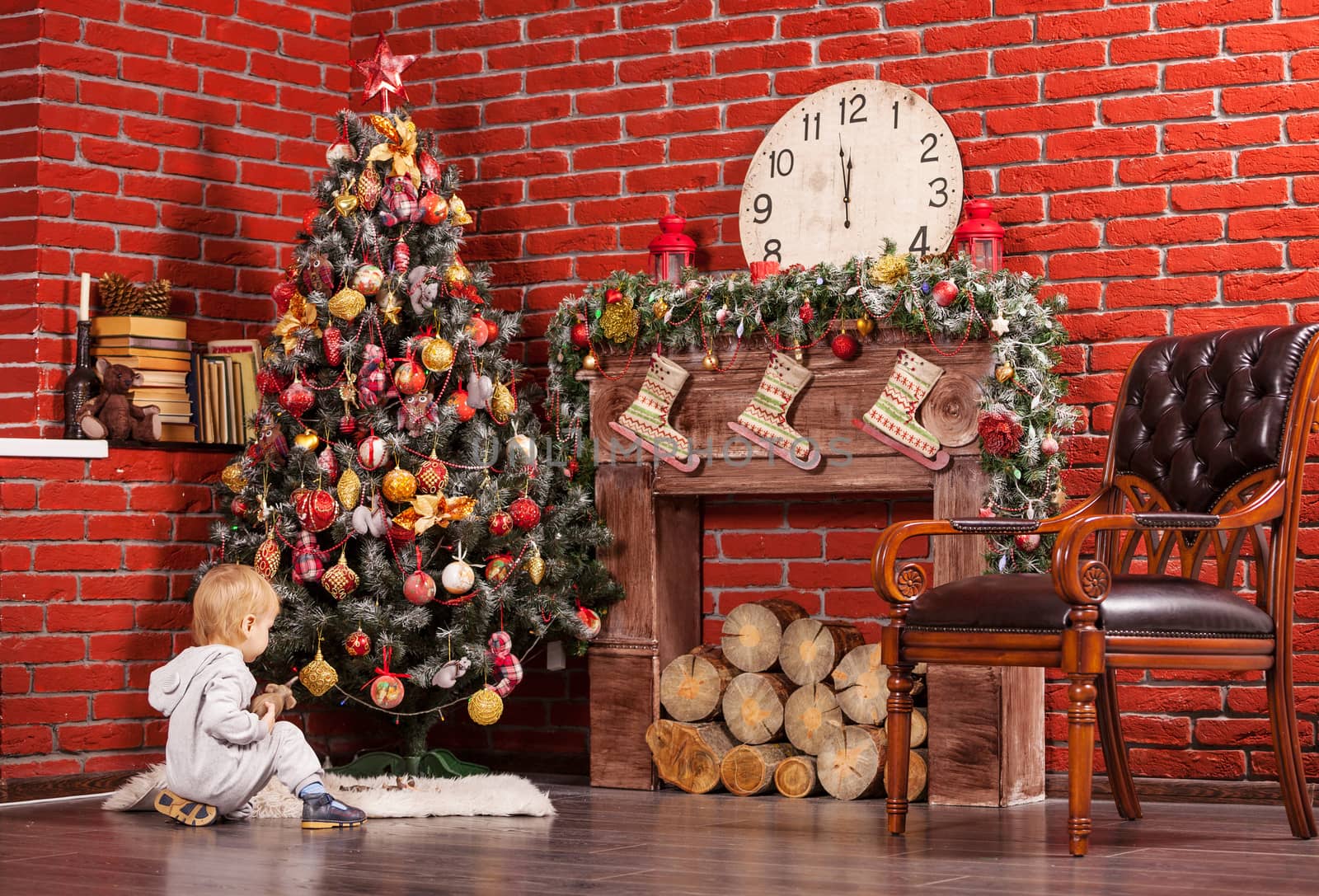 Blonde little boy playing near Christmas tree by photobac