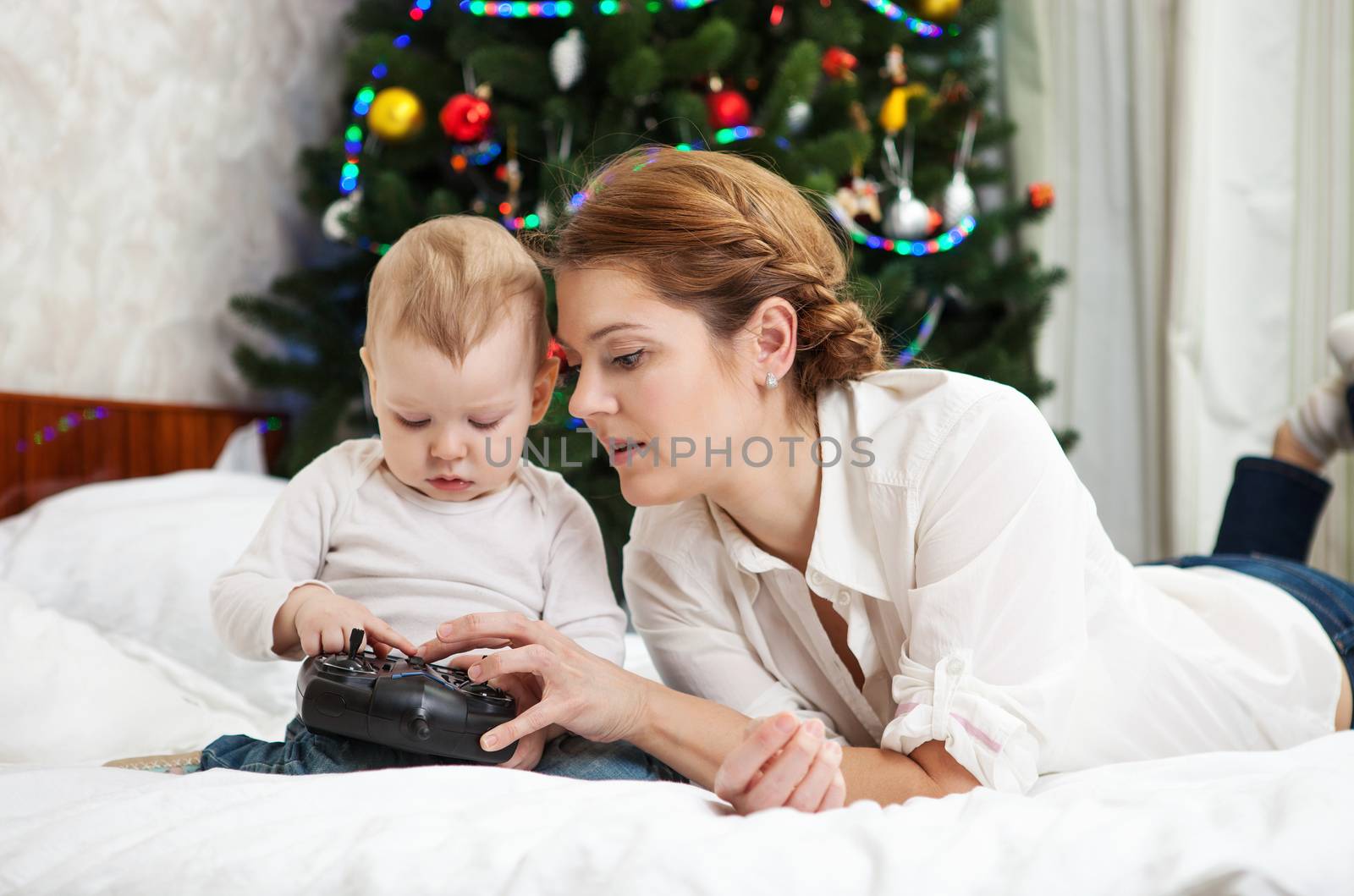 Mother and toddler son playing with RC controller by photobac