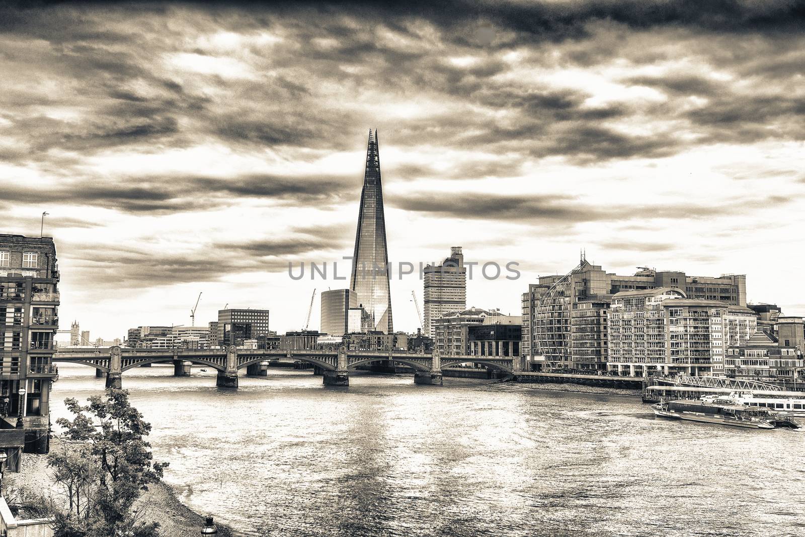 London skyline and Thames river on a cloudy day.