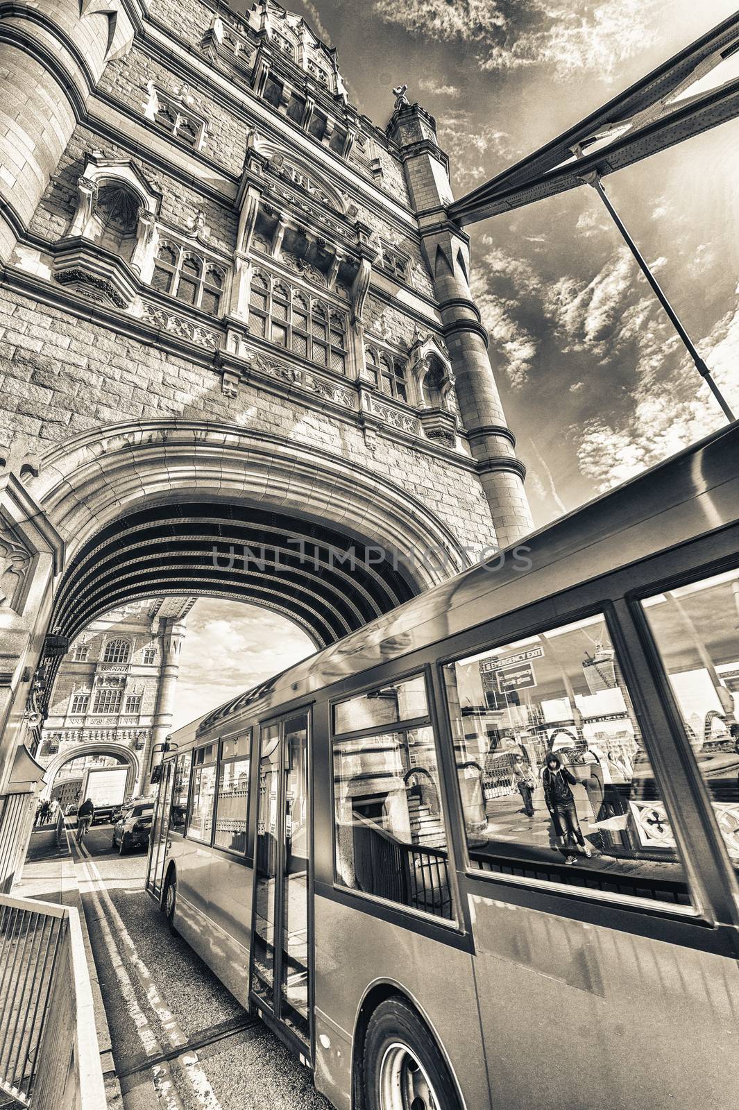 Double Decker bus crossing crowded Tower Bridge - London by jovannig