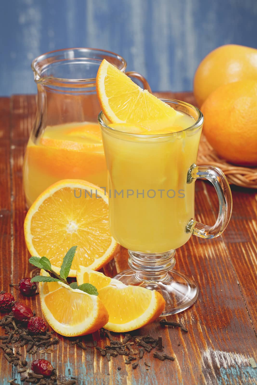 Orange juice and fresh oranges over rustic background. A macro photograph, shallow depth of field