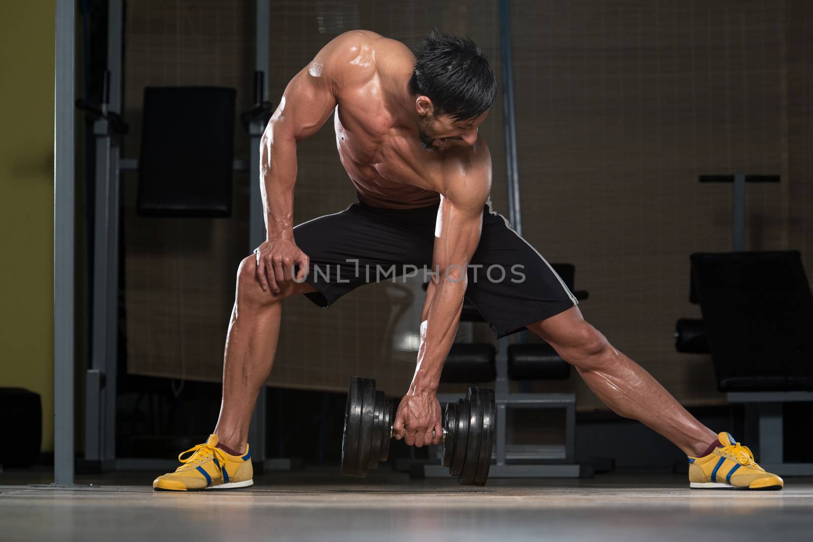 Fit Athlete Lifting Heavy Dumbbell
