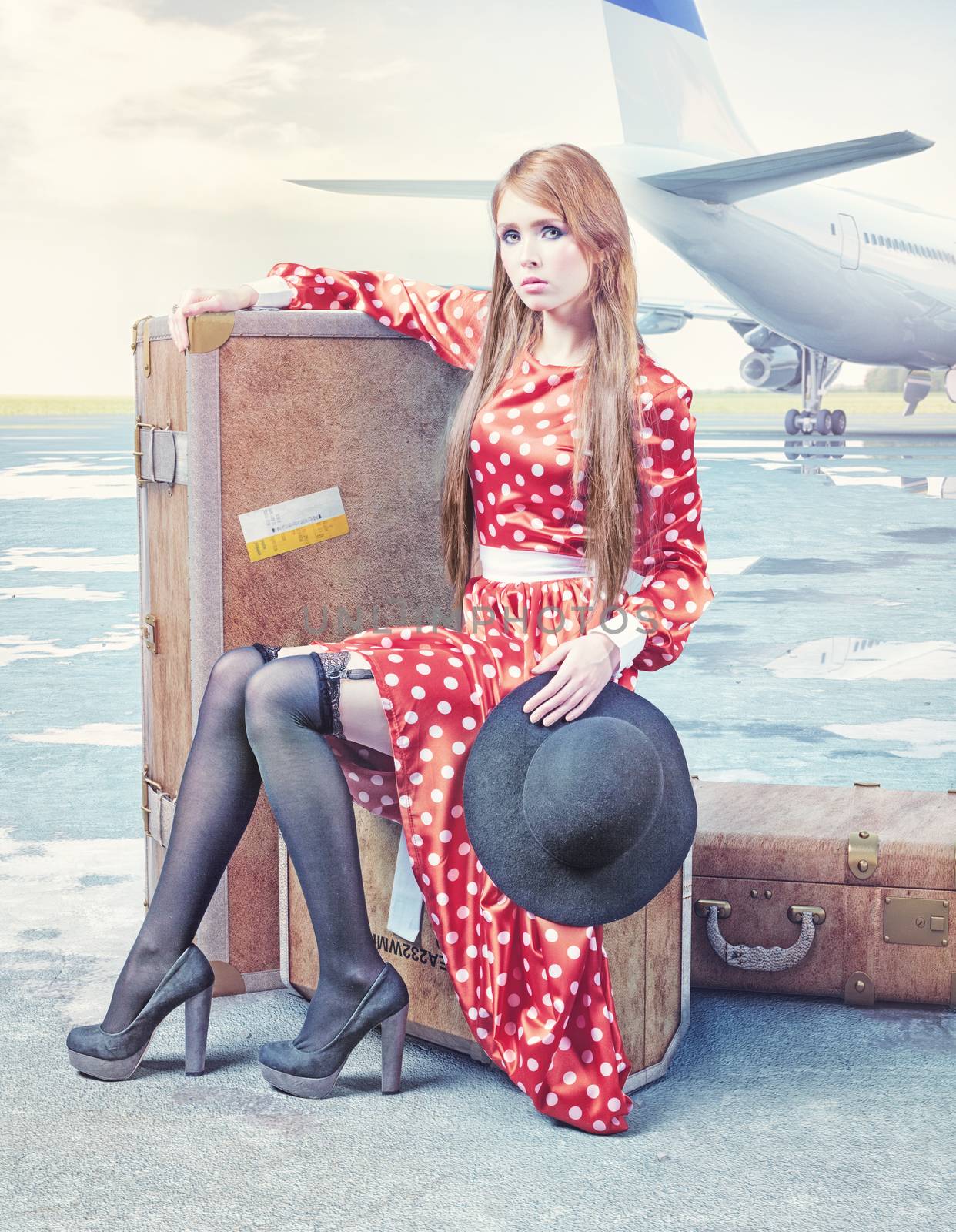 The beautiful young woman, waiting on the luggage in an airport.