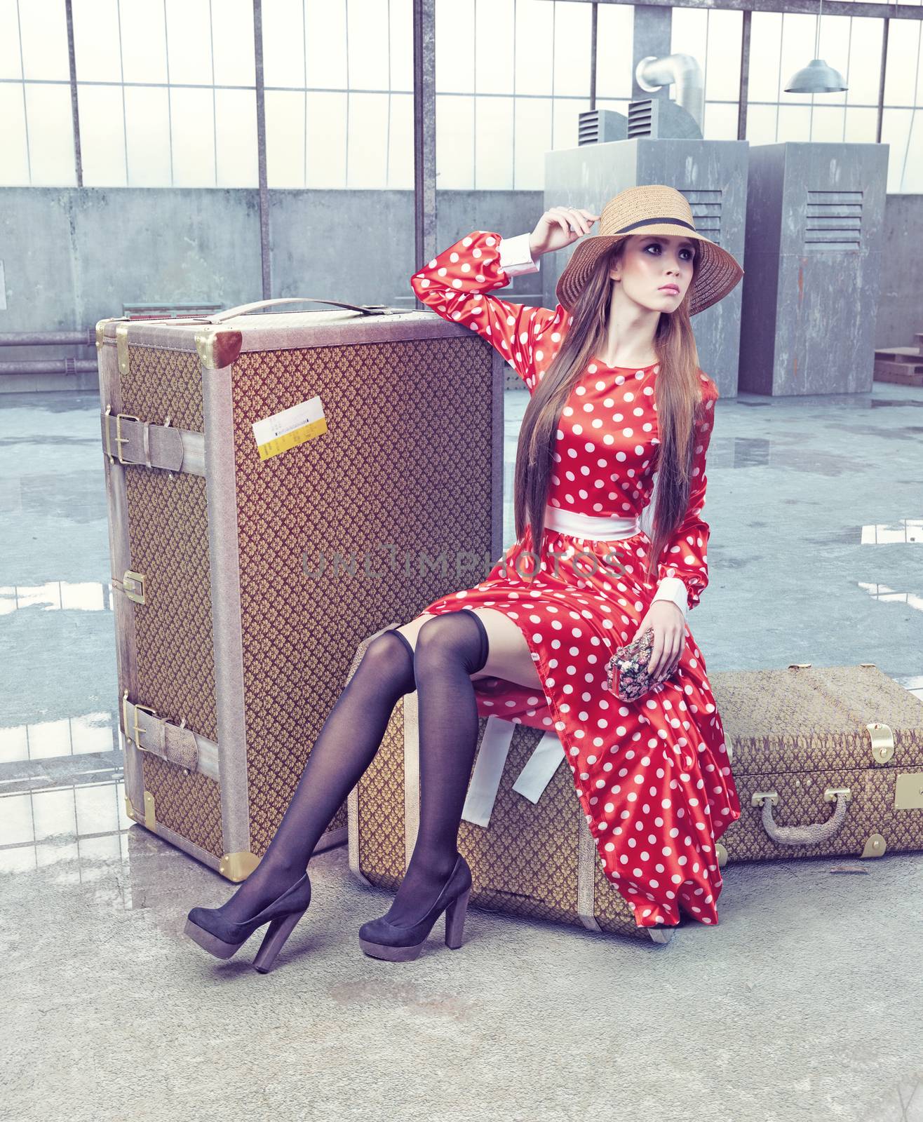 girl sitting on a suitcase waiting for travel