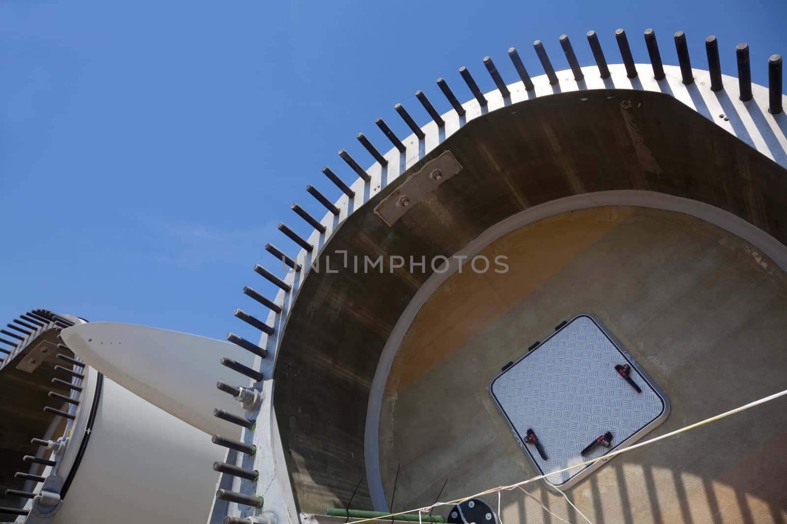 Giant wind turbine awaiting assembly at wind farm.