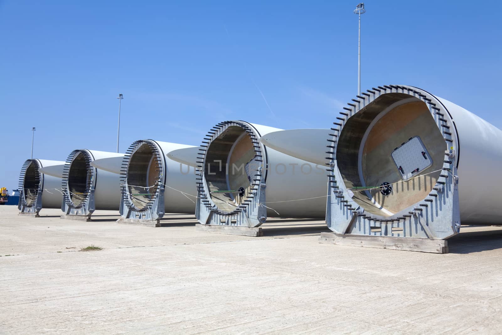 Giant wind turbine awaiting assembly at wind farm.