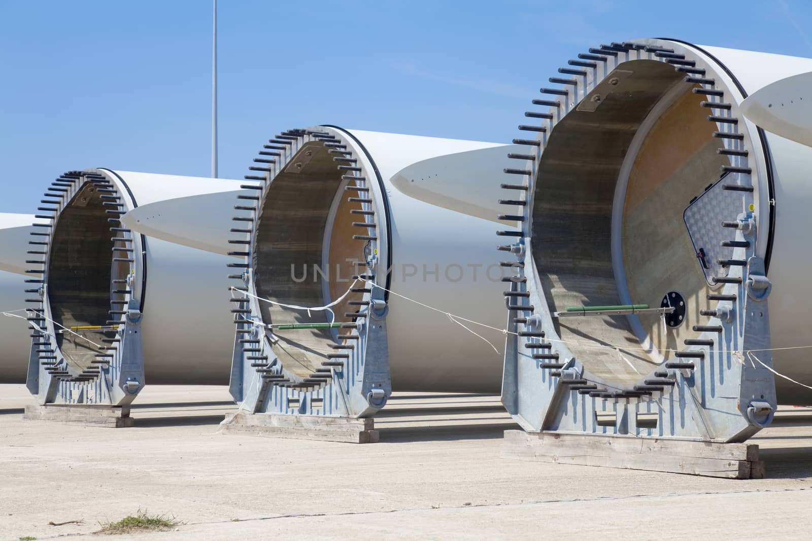 Giant wind turbine awaiting assembly at wind farm.