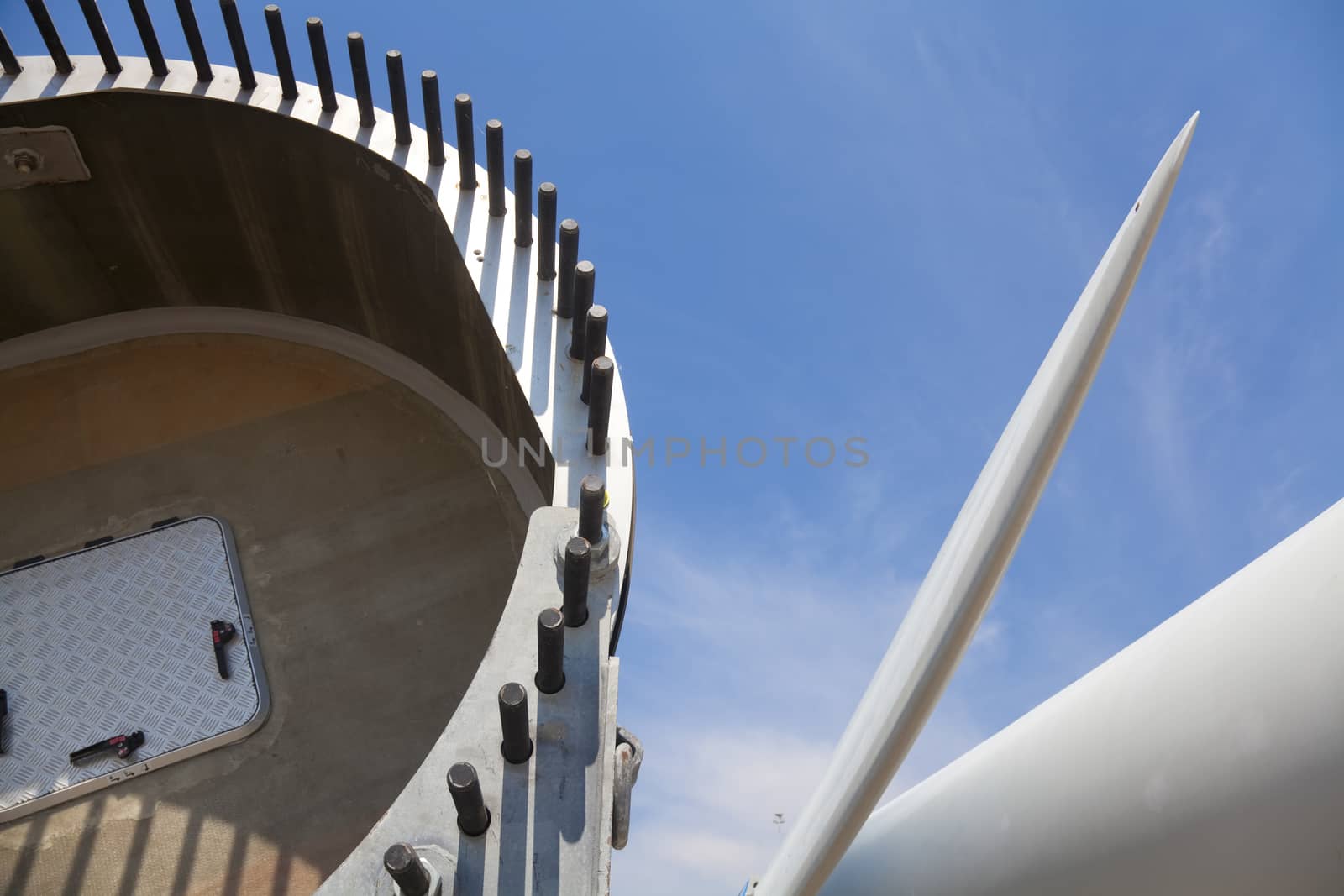 Giant wind turbine awaiting assembly at wind farm.