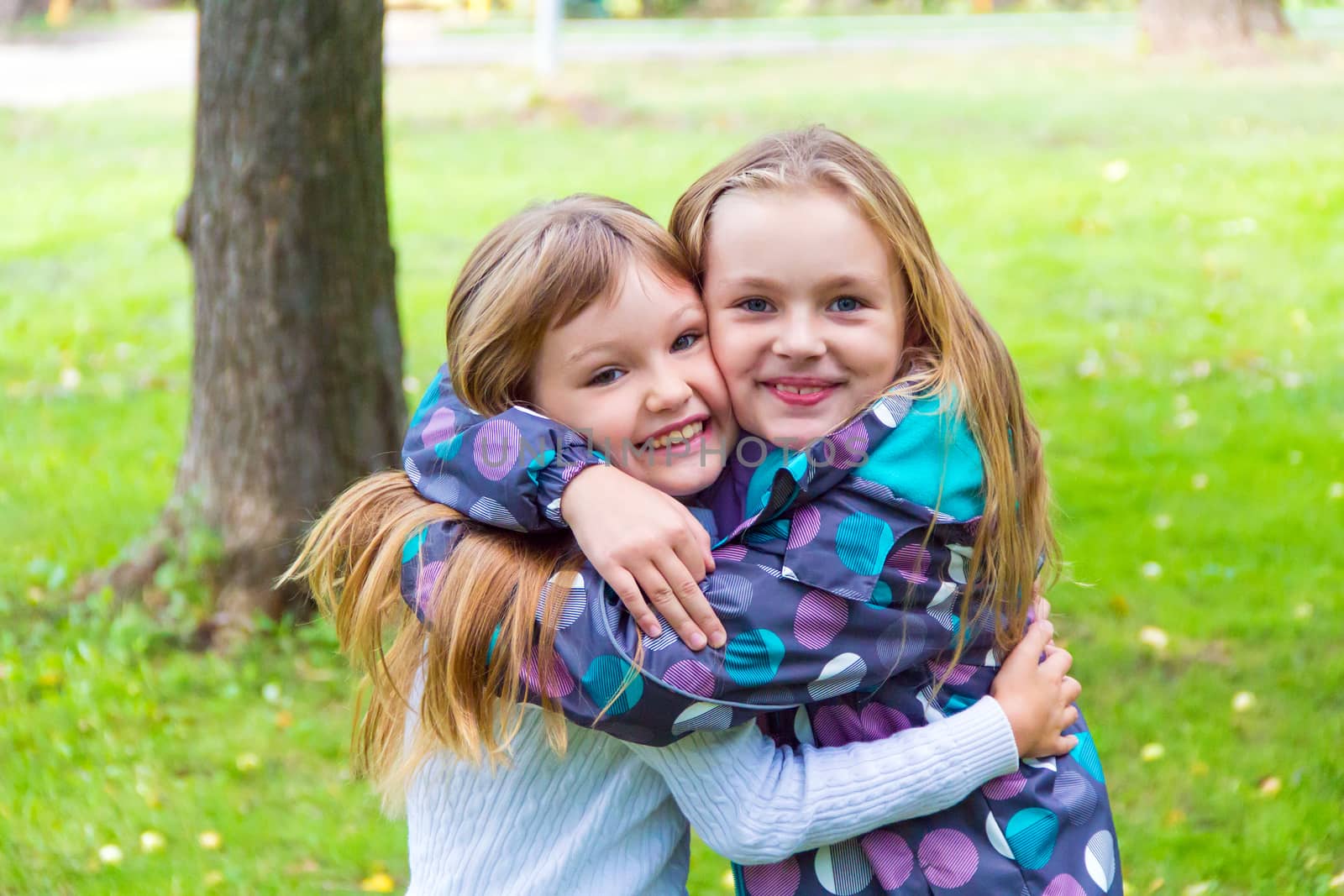 Photo of two playing girls in summer