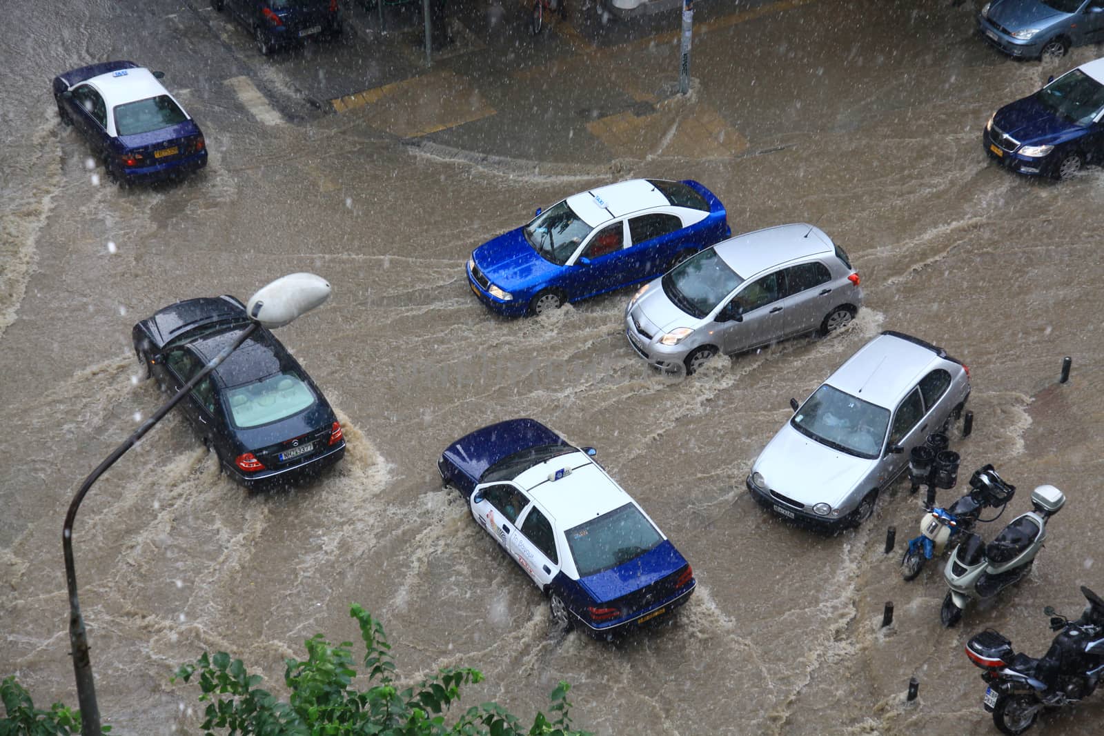 Thessaloniki, Greece - June 15, 2011: People try to cross a flooded road in the center of city. The summer months are a common phenomenon reason for the poor maintenance of drains