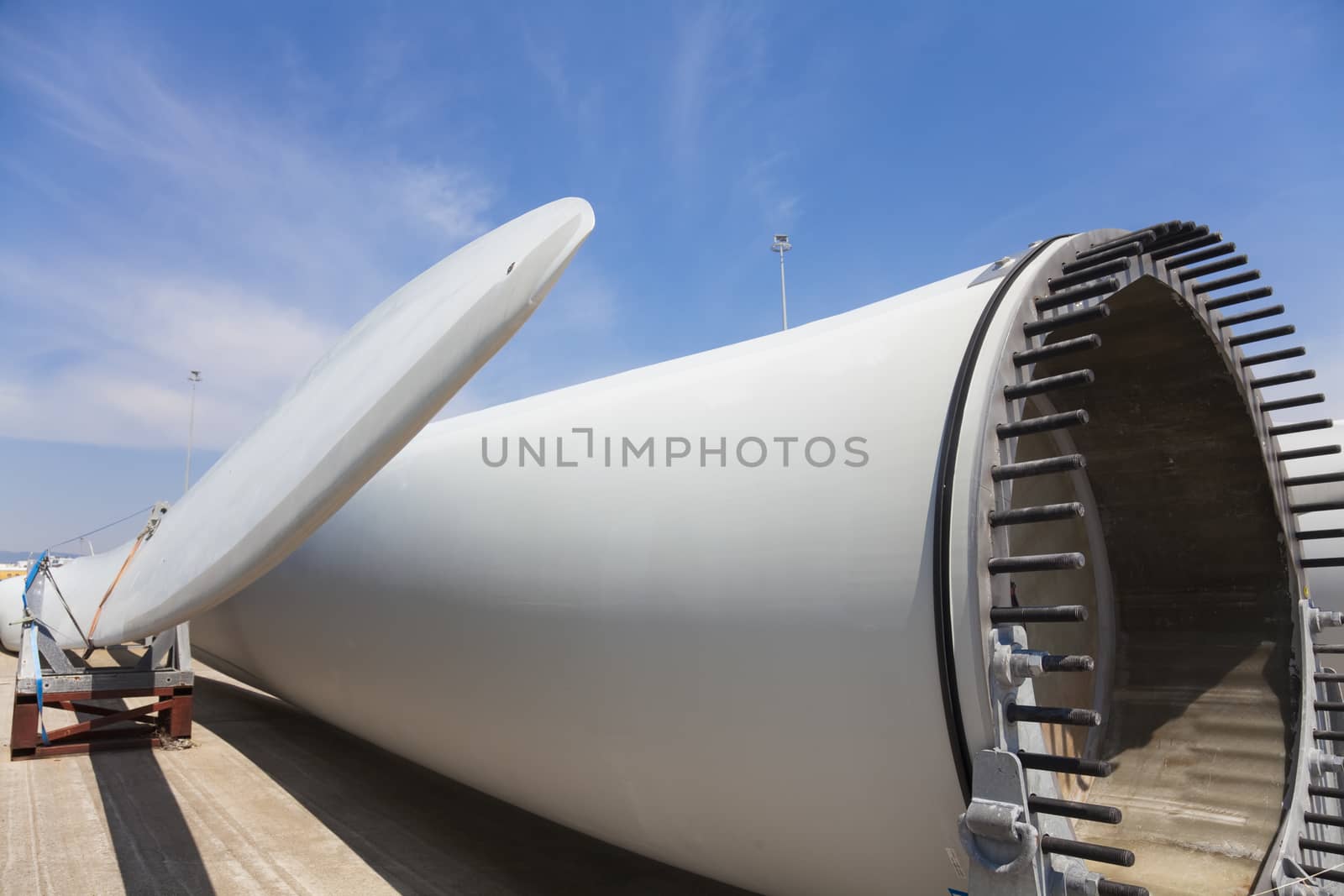 Giant wind turbine awaiting assembly at wind farm.