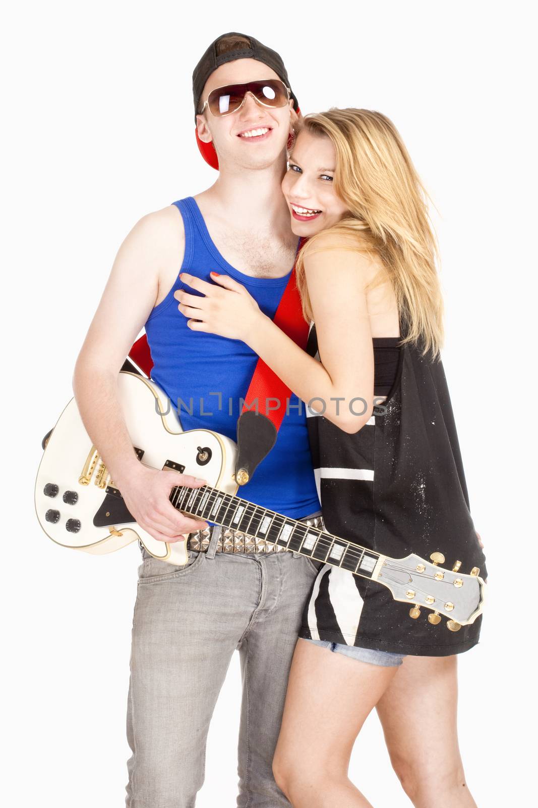 Teenage Couple - Girl Embracing her Boyfriend with Guitar - Isolated on White