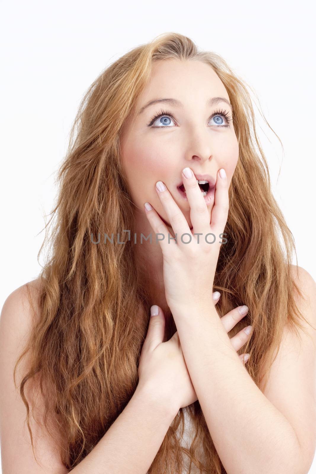 Young Woman with Long Brown Hair Looking Surprised, Hands on her Mouth