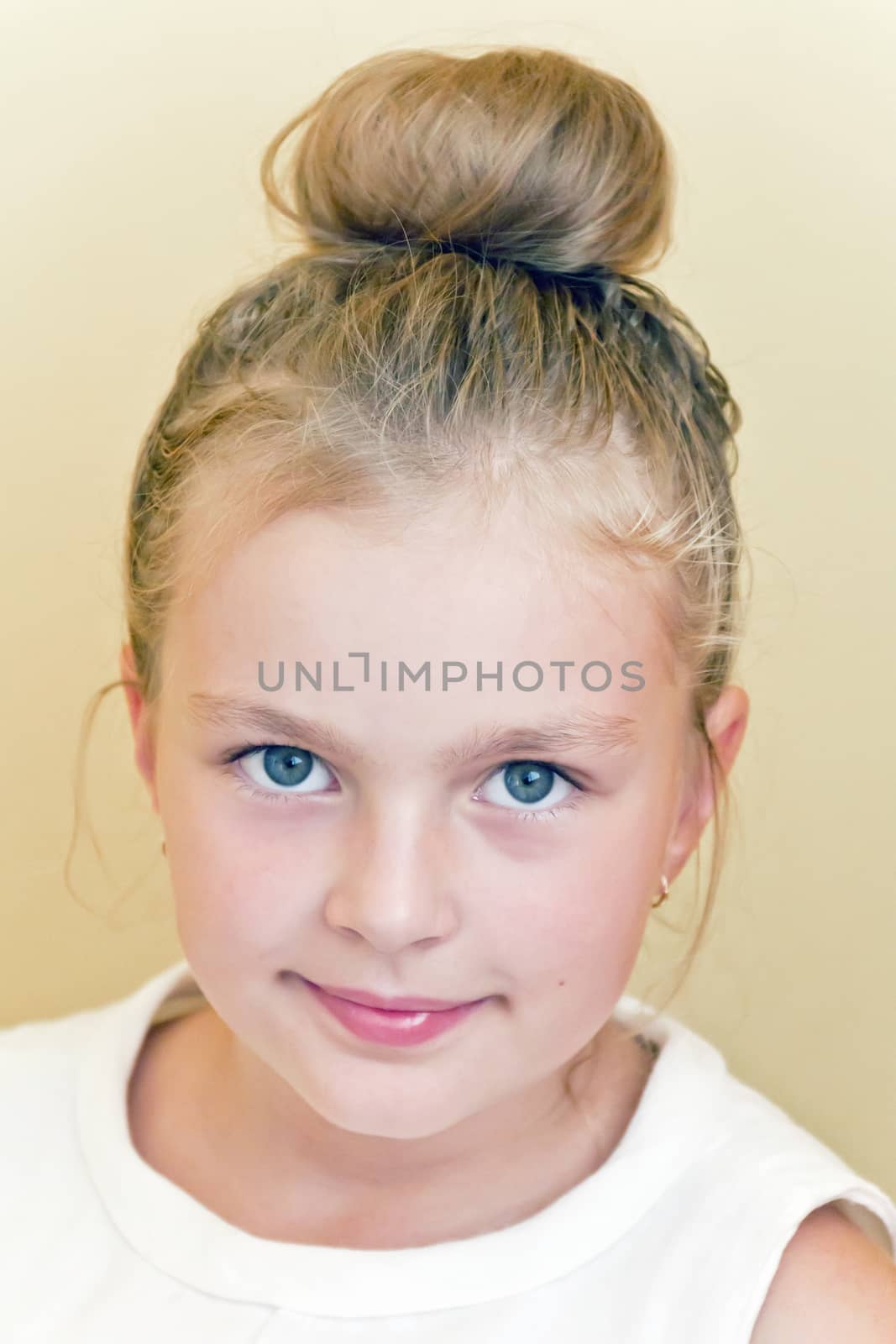 Cute girl with blond long hair and blue eyes