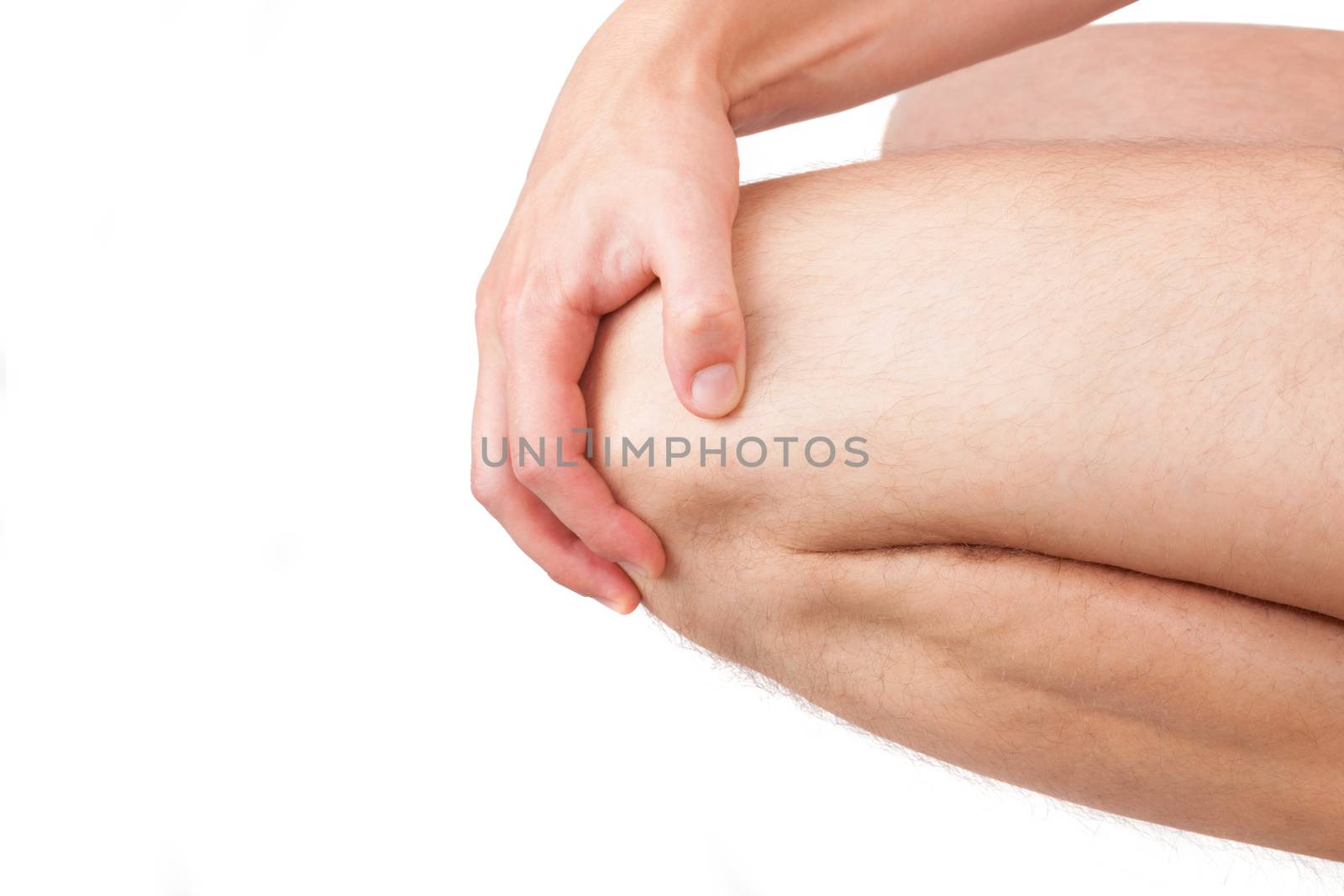 Man holding his naked knee isolated on white background. Knee injury and pain. Knee detail, close up. 
