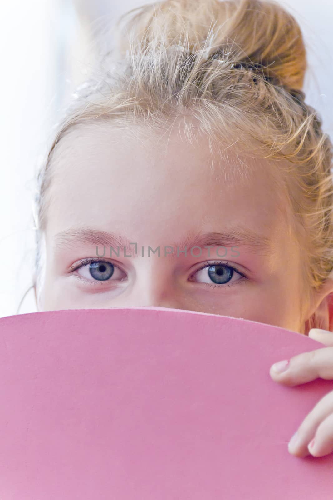 Cute girl with blond long hair and blue eyes