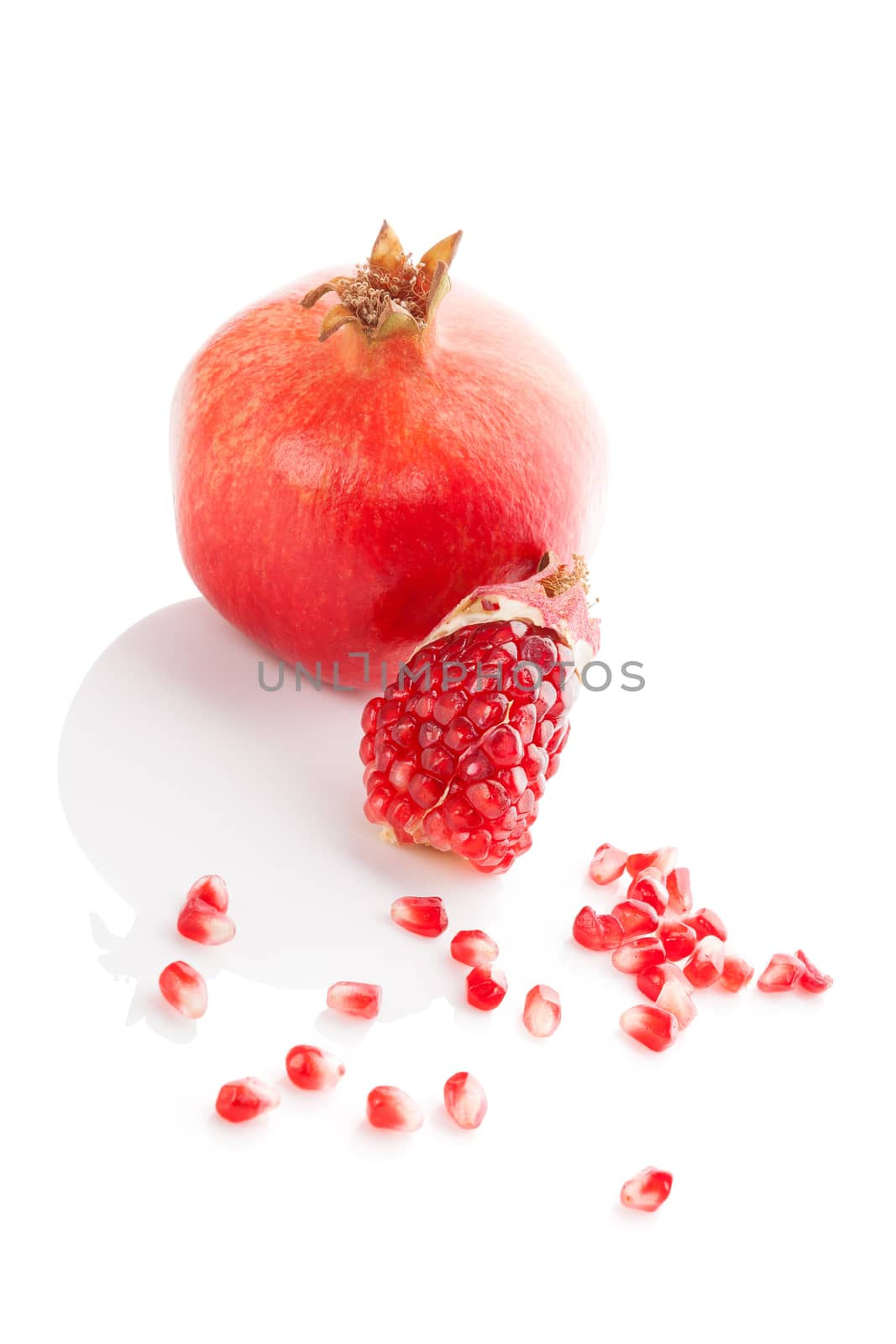 Pomegranate isolated on white background. Healthy fruit eating.