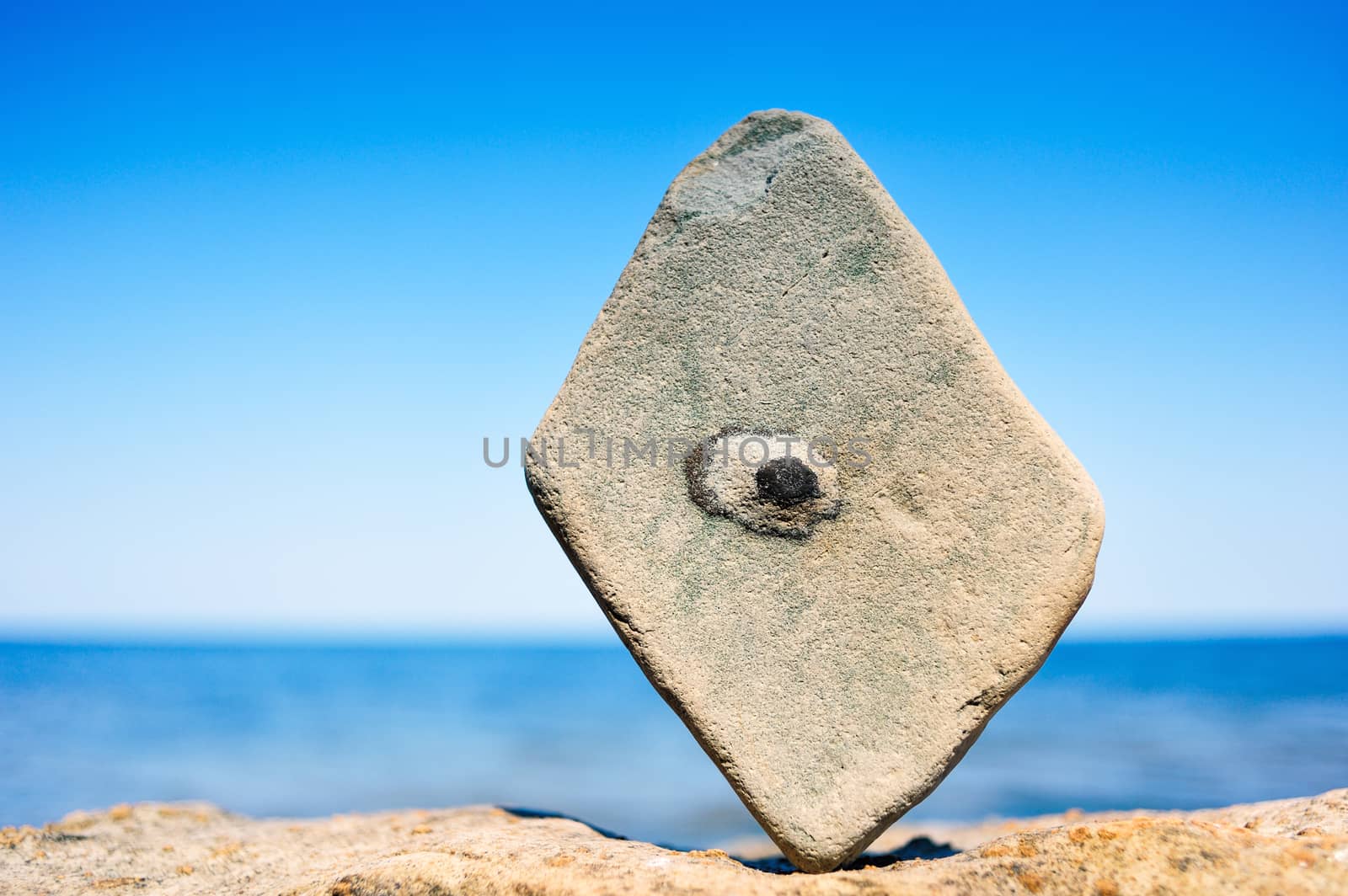 Rectangular stone in balance on the seacoast