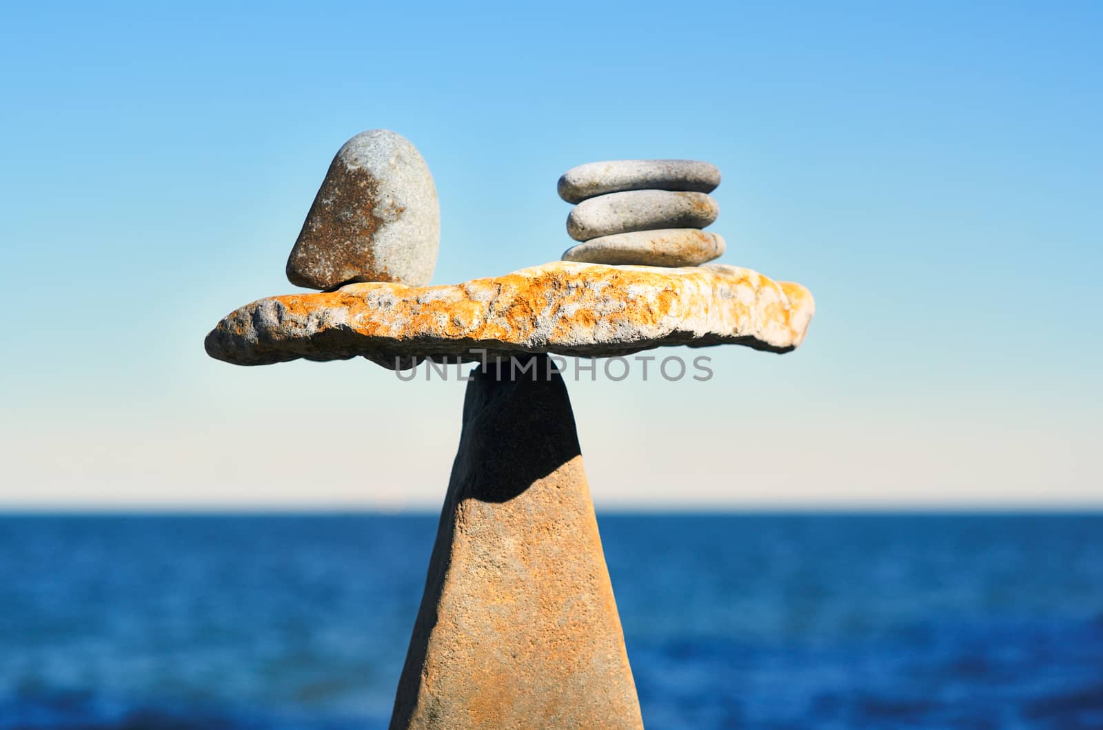 Balancing of pebbles on the top of triangle stone