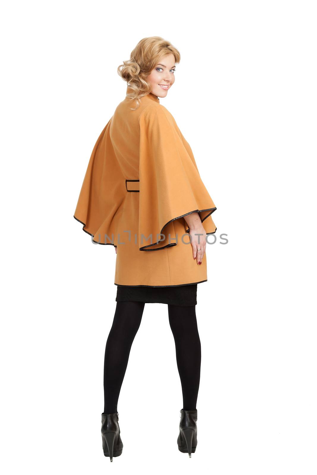 The girl in a yellow autumn coat on a white background