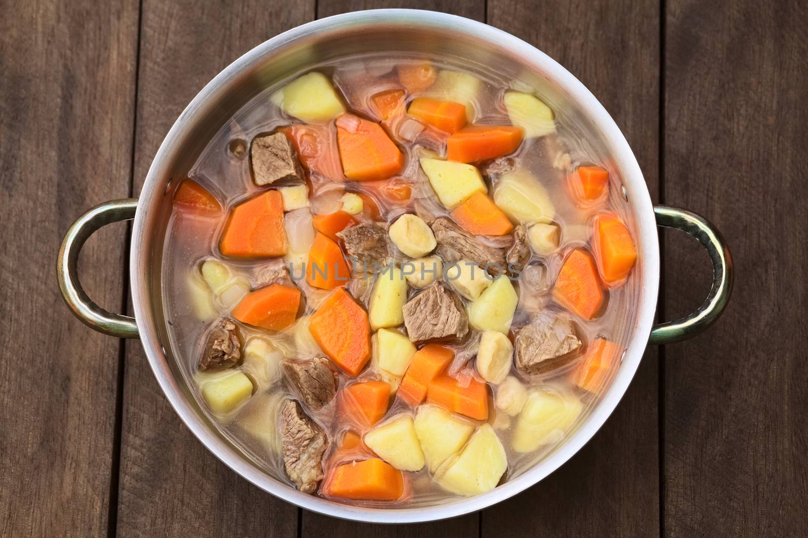 Pot filled with traditional Hungarian soup called Gulyasleves made of beef, potato, carrot, onion, csipetke (homemade pasta) and seasoned with salt and paprika (Selective Focus, Focus on the lower half of the soup)