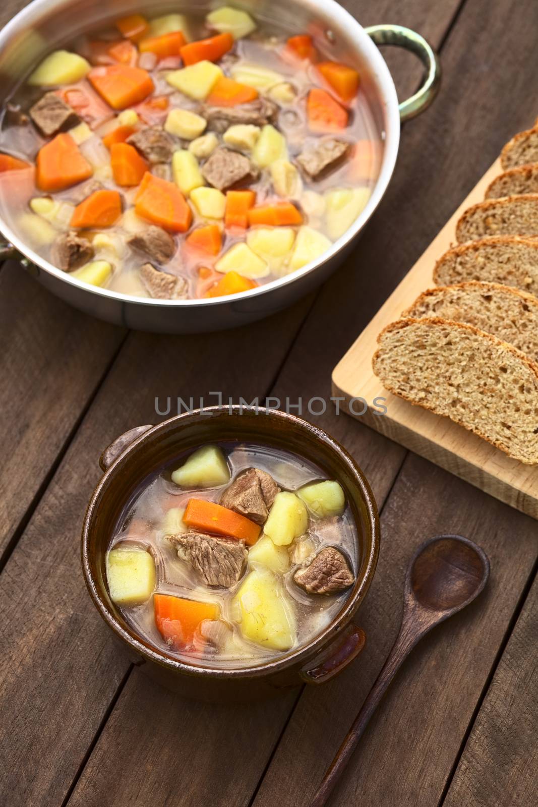 Bowl filled with traditional Hungarian soup called Gulyasleves made of beef, potato, carrot, onion, csipetke (homemade pasta) and seasoned with salt and paprika (Selective Focus, Focus on the lower half of the soup in the bowl)