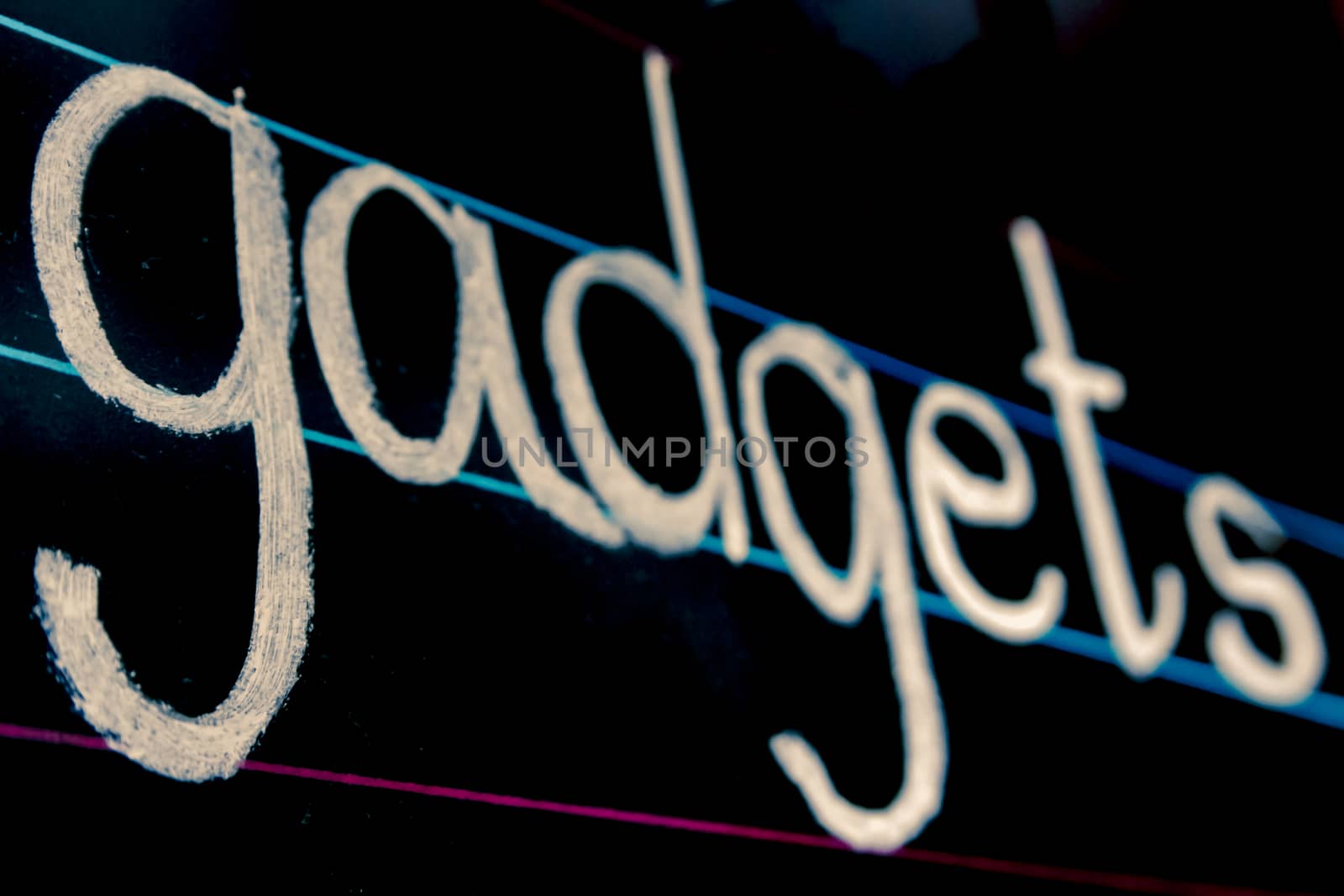 gadgets phrase handwritten on blackboard by yands