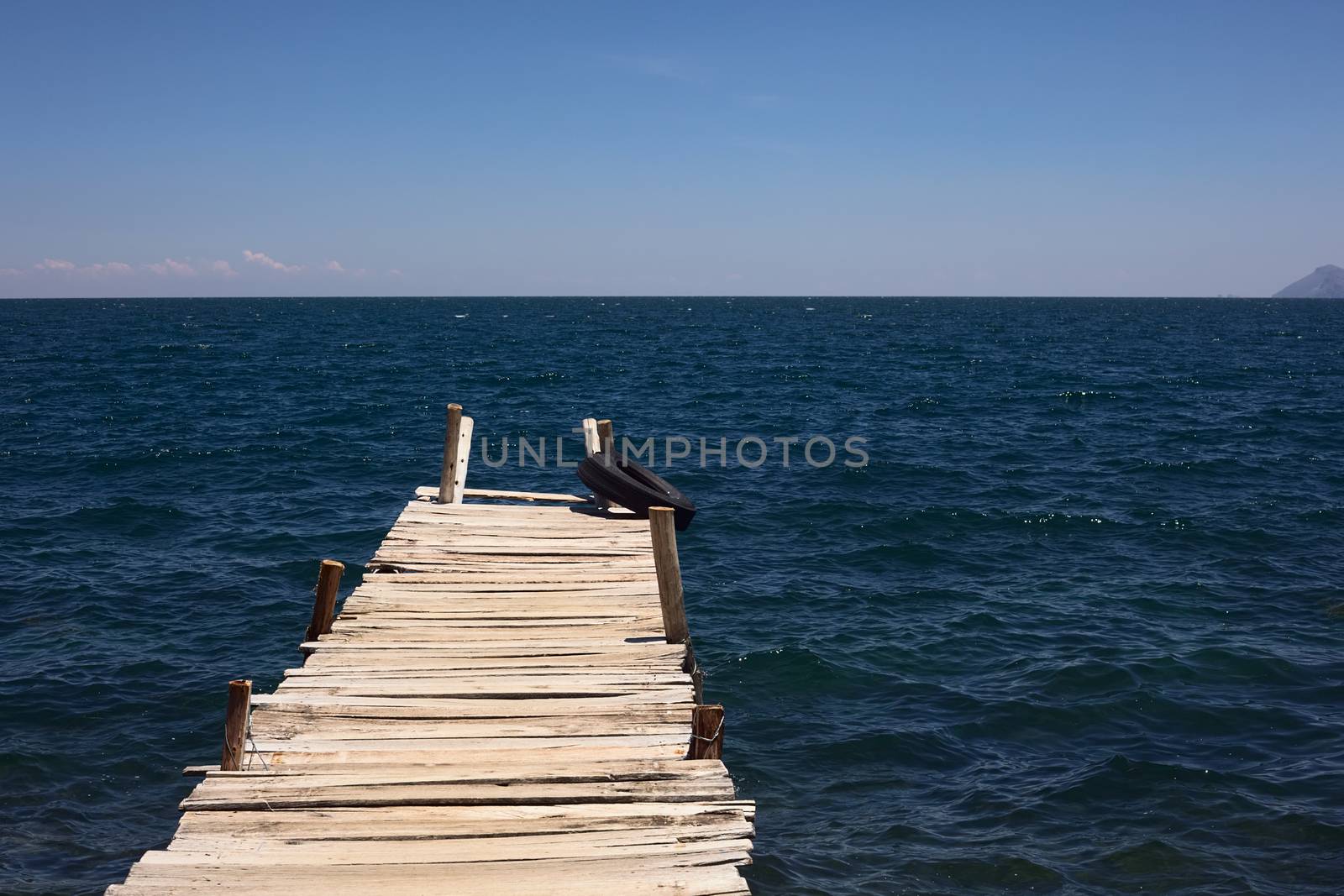 Wooden jetty leading into Lake Titicaca close to the small tourist town of Copacabana in Bolivia